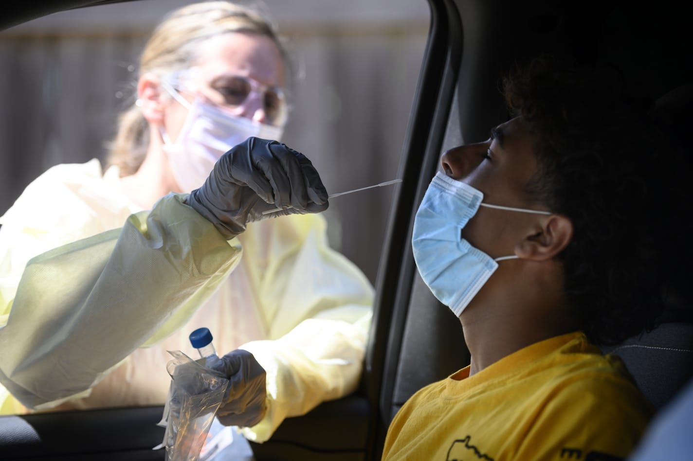 North Memorial RN Andrea Driskill administered a COVID-19 test to Dominick Brown, 15, Wednesday afternoon behind the North Memorial Speciality Center in Robbinsdale. Brown is being tested due to possible exposure to the virus. ] aaron.lavinsky@startribune.com Healthcare workers tested drive-up and walk-up patients for COVID-19 behind the North Memorial Health Specialty Center on Wednesday, July 29, 2020 in Robbinsdale, Minn.