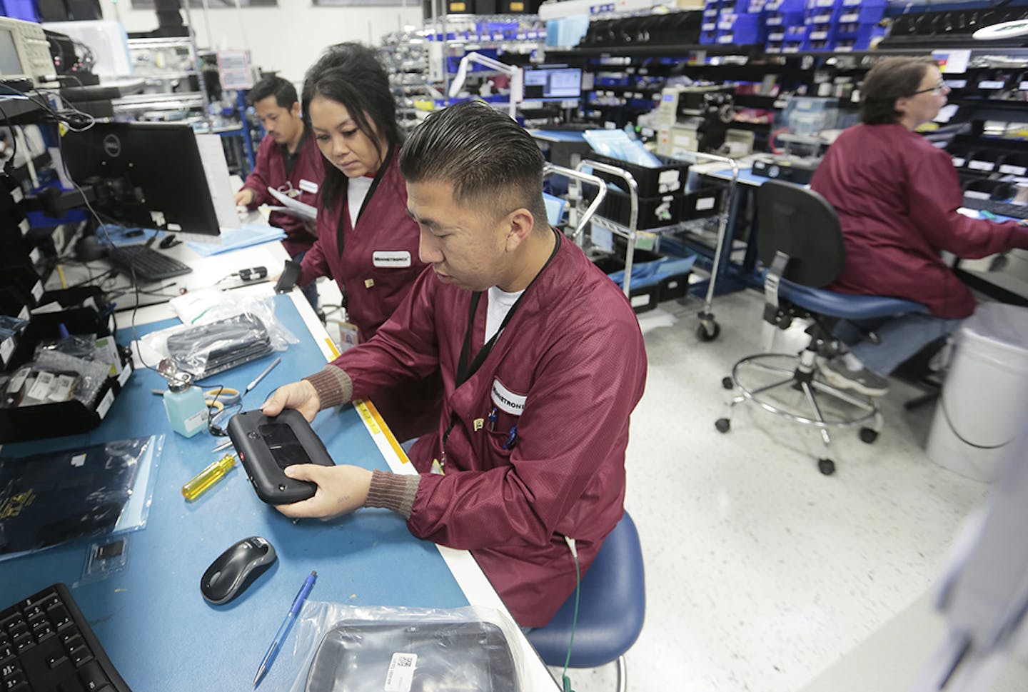 Workers at the Minnetronix manufacturing facility in St. Paul