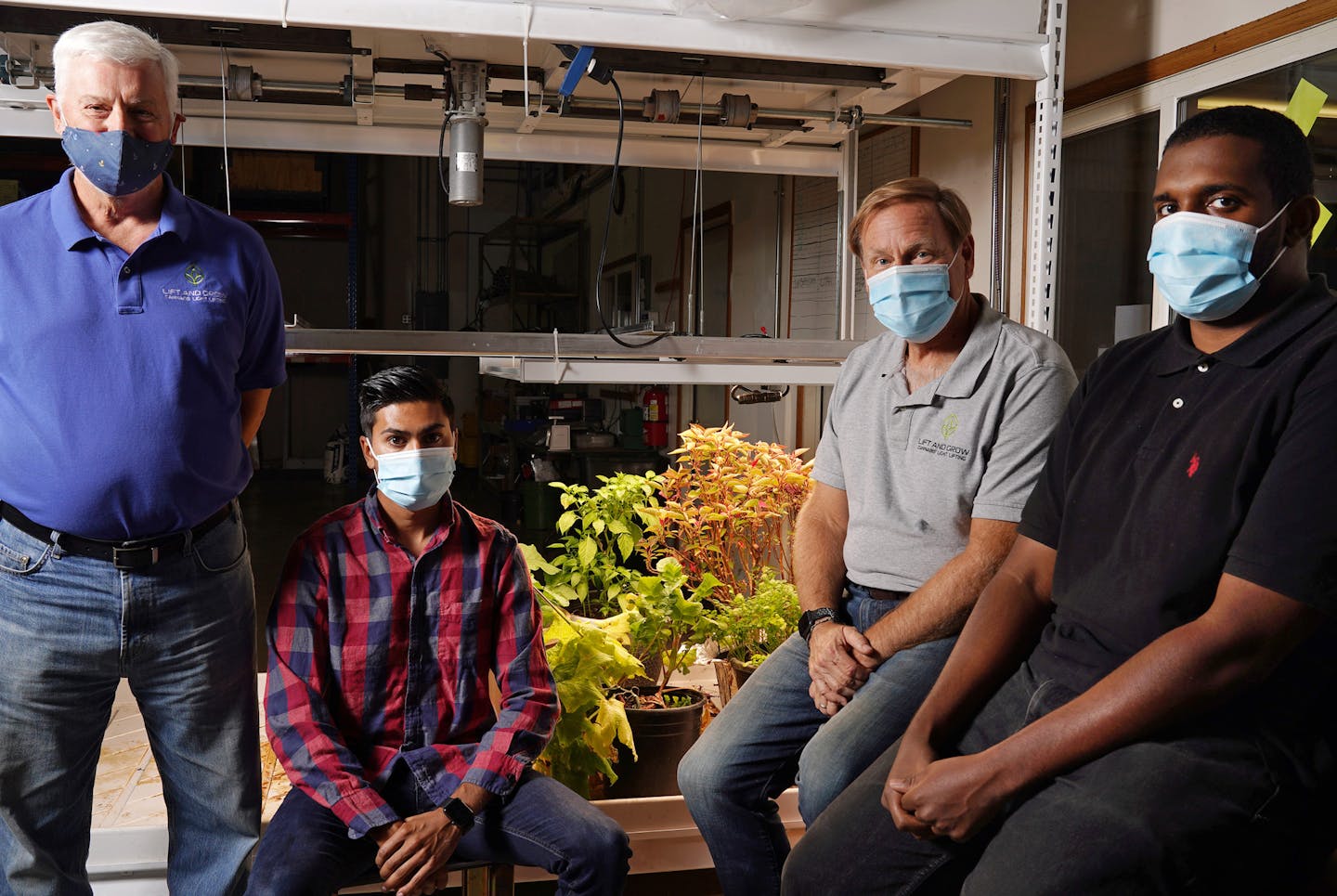 From left, Lift and Store marketing director George Johnson, supply chain manager Caleb Steeves, CEO Chris Benyo, and mechanical engineering intern Mohamed Noor sat for a portrait beside one of the company's cannabis light lifts Wednesday. ] ANTHONY SOUFFLE • anthony.souffle@startribune.com From left, Lift and Store marketing director George Johnson, supply chain manager Caleb Steeves, CEO Chris Benyo, and mechanical engineering intern Mohamed Noor sat for a portrait beside one of the company's