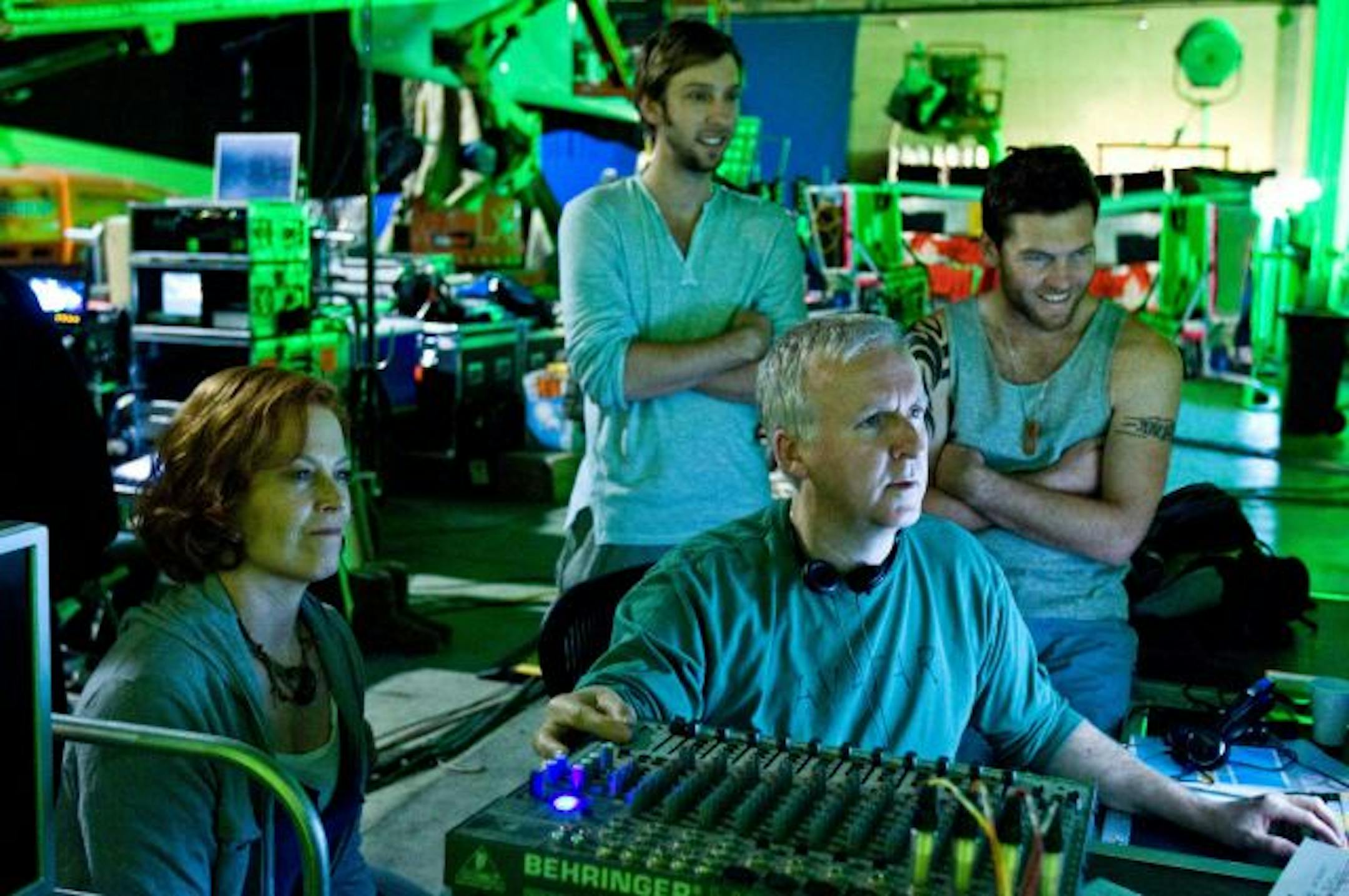 In this image released by 20th Century Fox, writer-director James Cameron, foreground right, reviews a scene with actors, from left, Sigourney Weaver, Joel David Moore and Sam Worthington during the filming of, "Avatar."