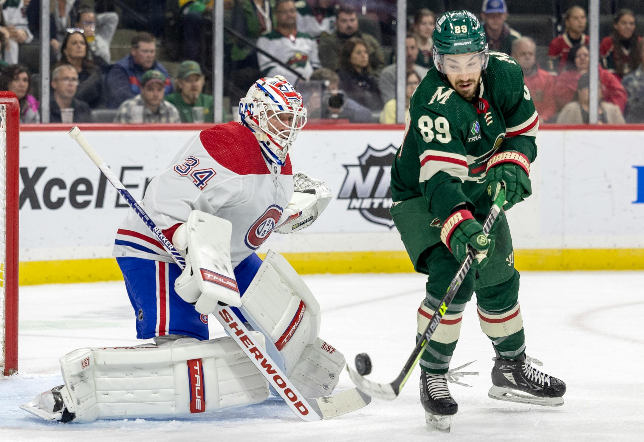 Montreal Canadiens goalie Jake Allen (34) watches as Frederick Gaudreau (89) of the Minnesota Wild handles the puck near the crease in the first period.
