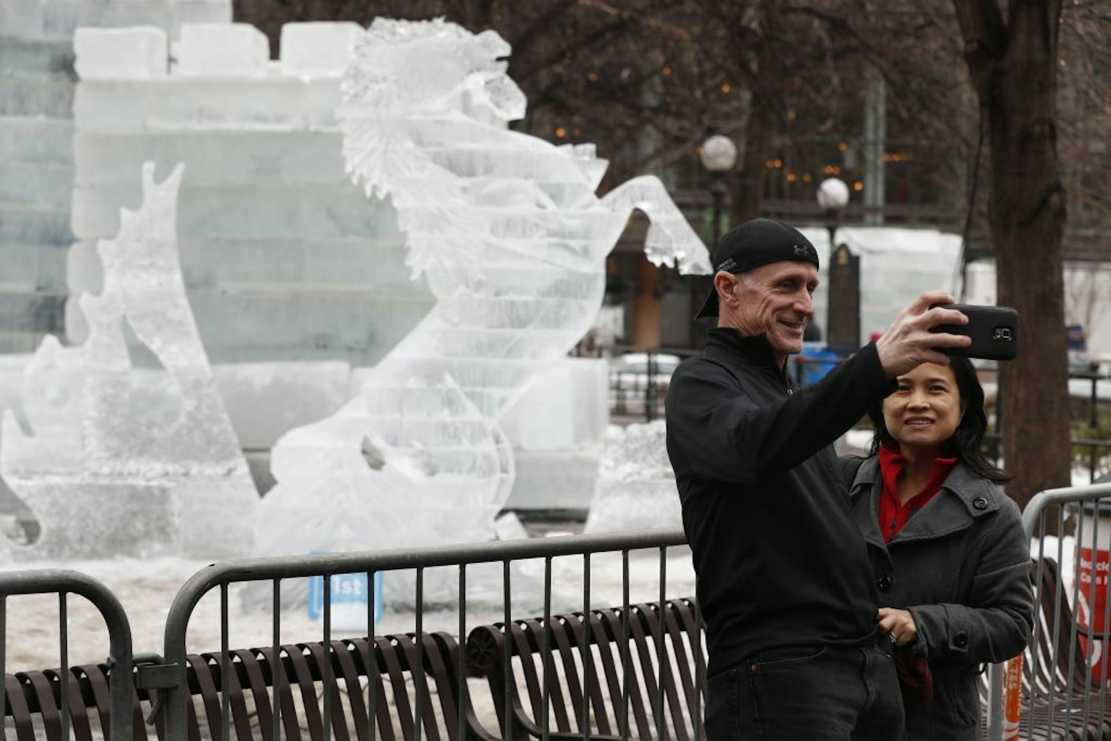 Ron Corbett and his wife Lany Corbett took a photo with ice sculptures art Rice Park. The current mild temperature at this years Winter Carnival are melting the sculptures at Rice Park Tuesday January 31, 2017 in St. Paul, MN.