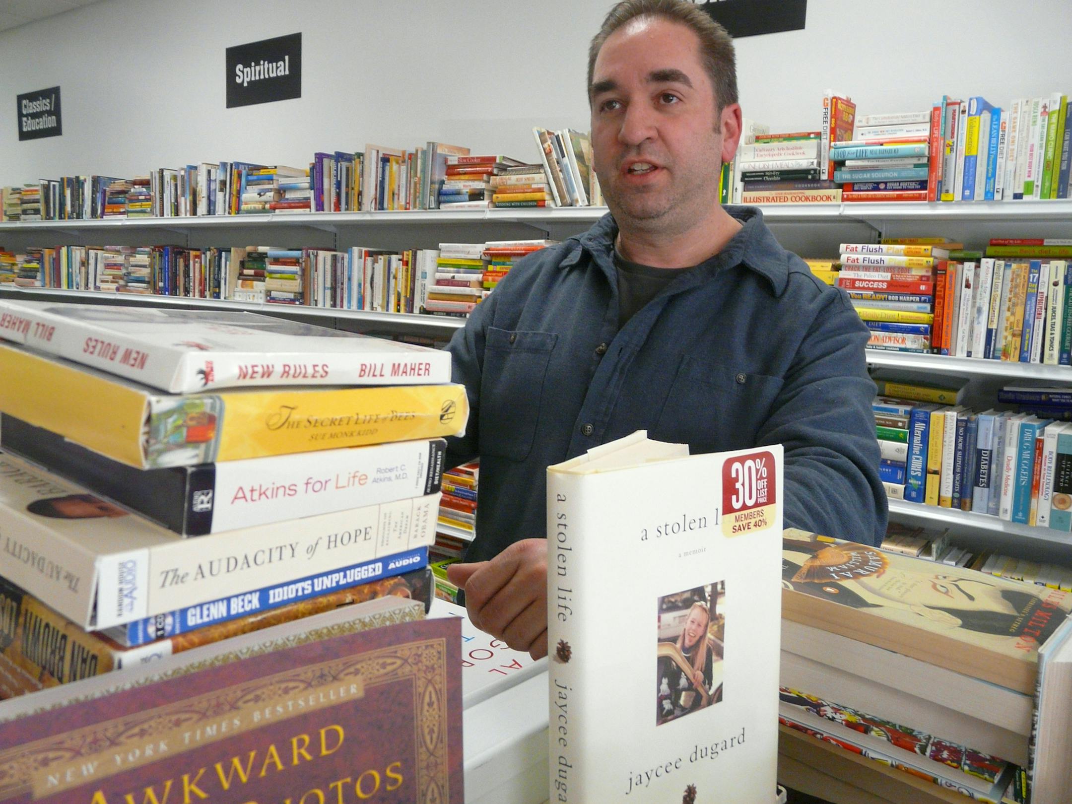 Jason Burbul at his store, "A Greener Read," in Woodbury. Photo by David Peterson