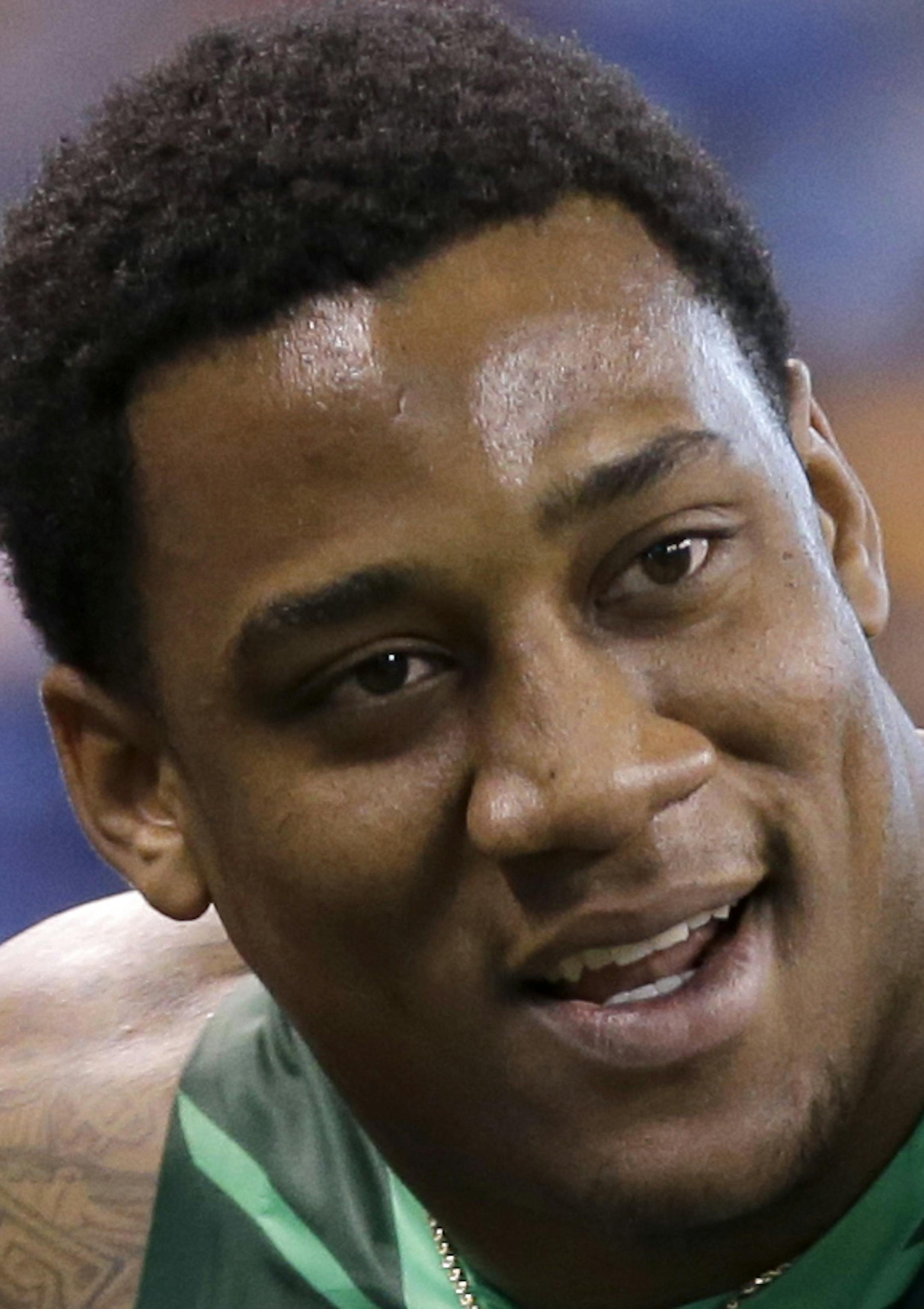 Louisville defensive lineman B.J. Dubose, center, is helped by Dallas Cowboys scout Kevin Simon, right, and NFL Trainer Marcus Davis after he fell upon finishing the 40-yard dash at the NFL football scouting combine in Indianapolis, Sunday, Feb. 22, 2015. (AP Photo/Julio Cortez) ORG XMIT: INJC112