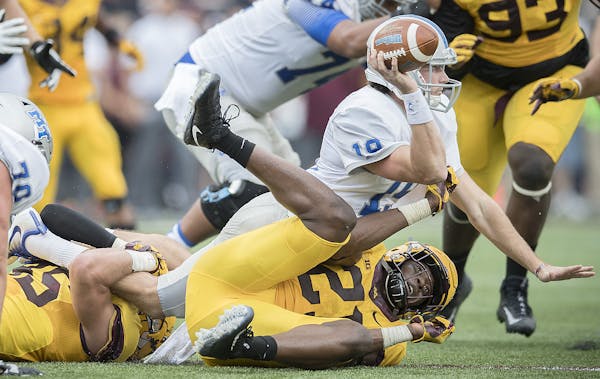 Minnesota's linebacker Kamal Martin and Carter Coughlin brought down Middle Tennessee's quarterback John Urzua during the second quarter as the Gopher