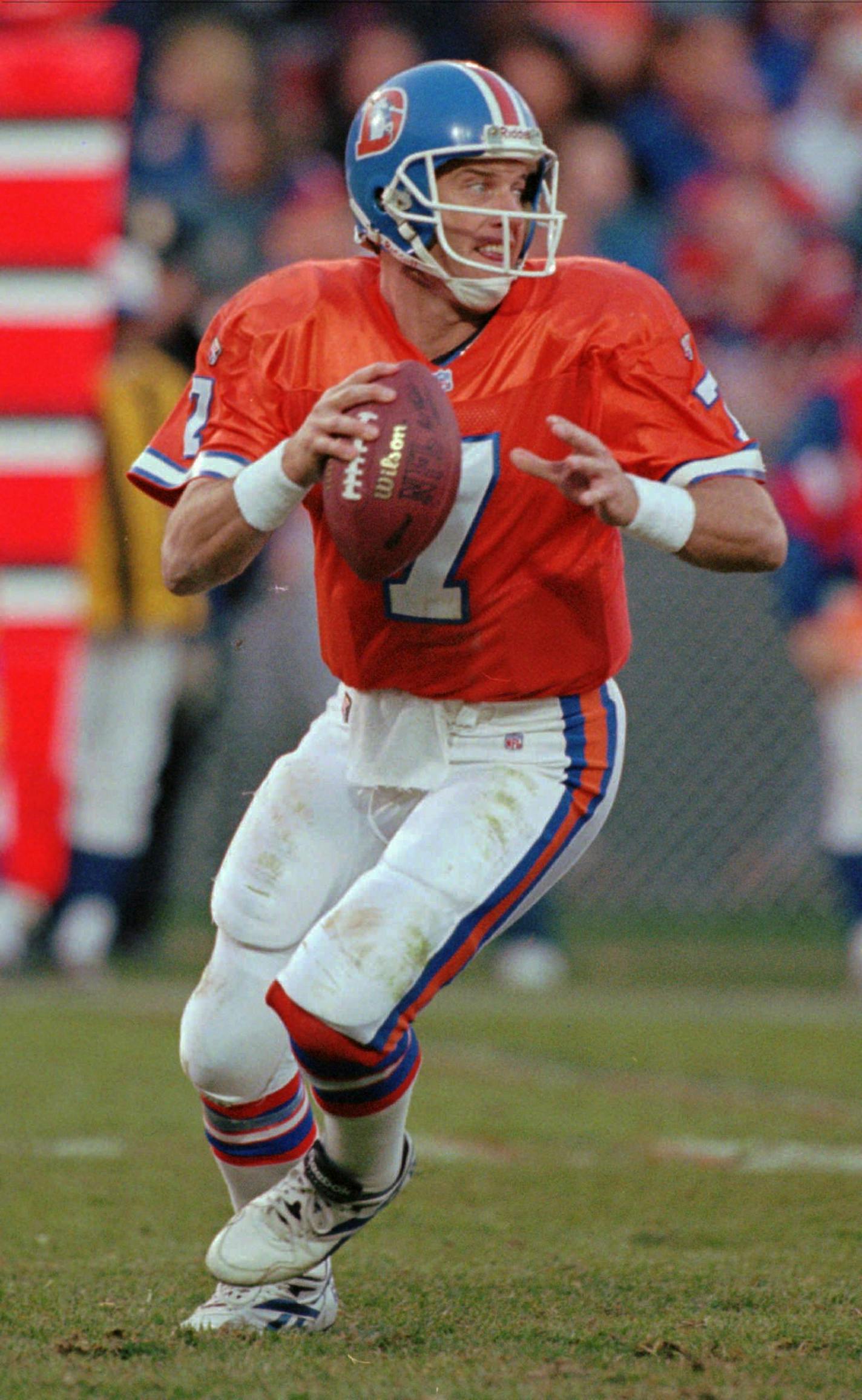 Denver Broncos quarterback John Elway sets to throw the ball to wide receiver Vance Johnson for a 23-yard gain in the fourth quarter in the Broncos' 38-6 victory over the Arizona Cardinals in Denver's Mile High Stadium on Sunday, Nov. 5, 1995. Elway cleared the 40,000 career passing yards mark later in the game. (AP Photo/Karl Gehring) ORG XMIT: DXS104