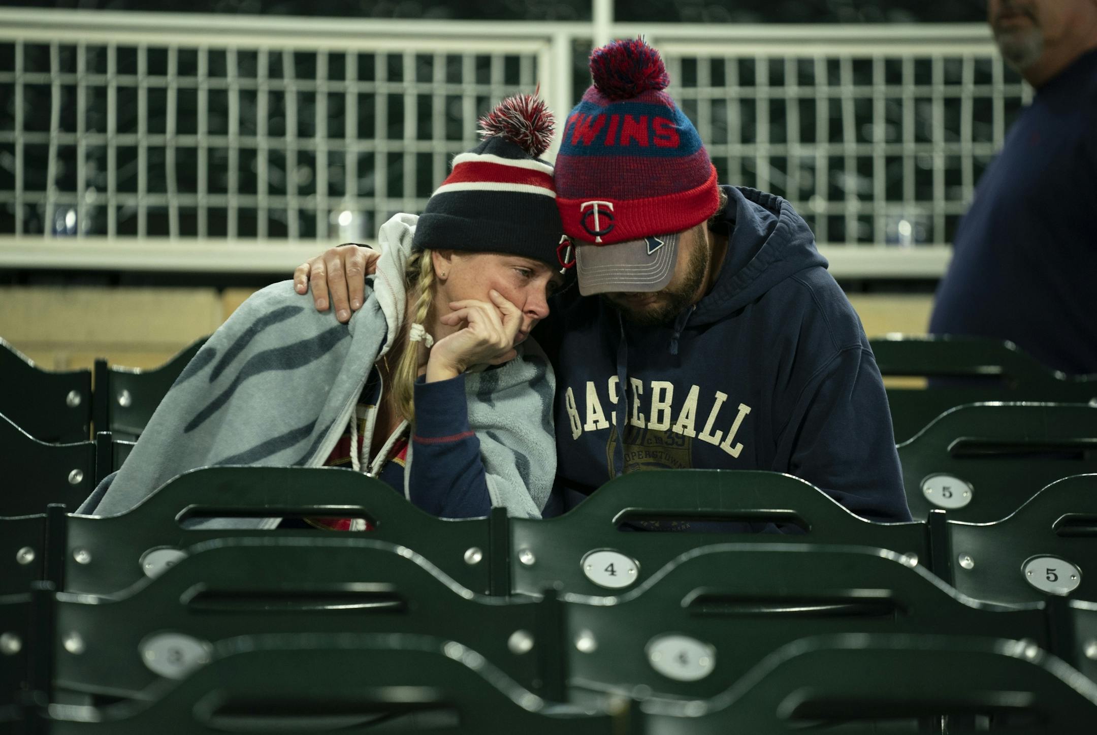 Stacey Green was consoled after the Twins loss by her partner, Steve Frenzel. The couple are from Plymouth. "It was heartbreaking to lose in three," Green said.