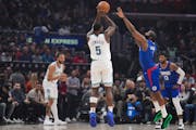 Timberwolves guard Anthony Edwards (5) shoots over Clippers guard James Harden during the first half Tuesday in Los Angeles.