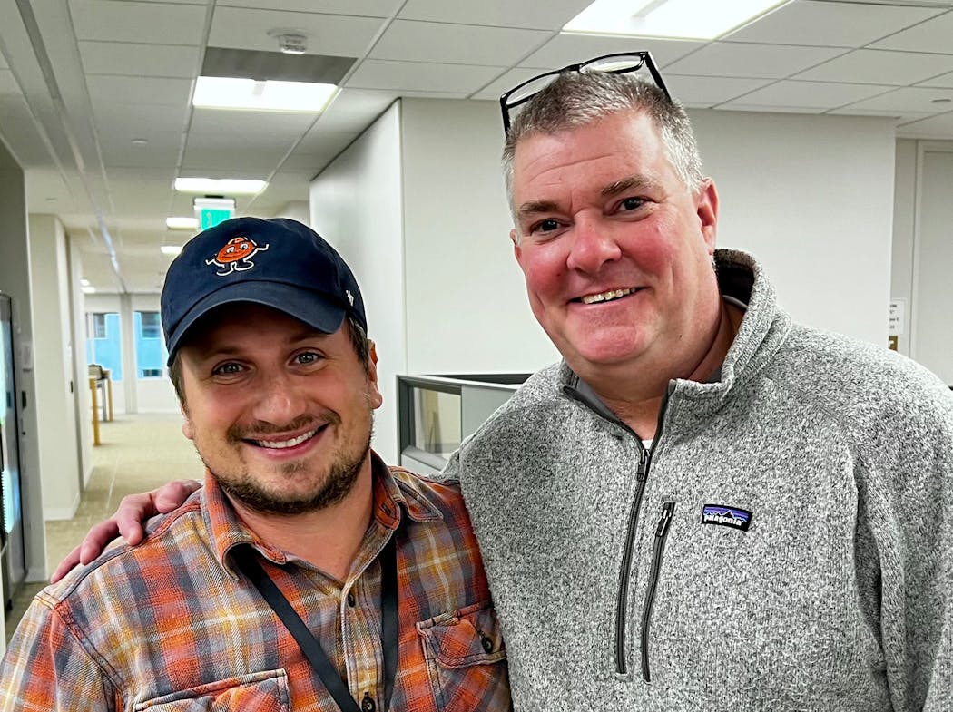 Photographer Aaron Lavinsky, left, and sportswriter Chip Scoggins posed for a photo together in the Star Tribune newsroom on the day their story on the Red Lake Nation football team was finalized. 