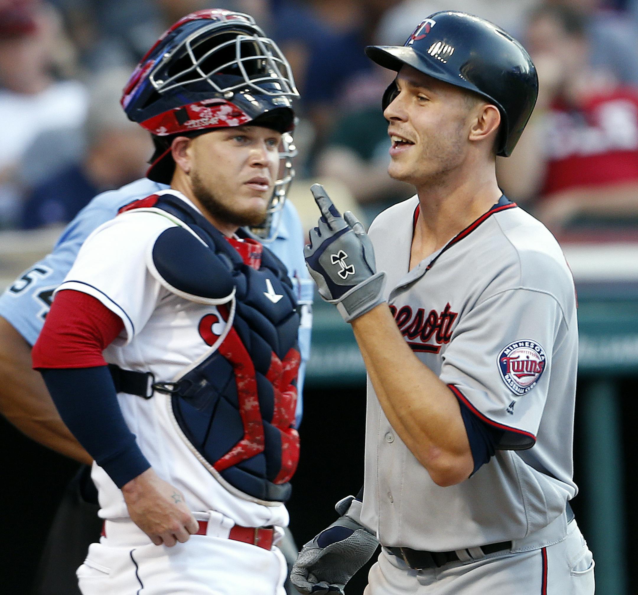 Minnesota Twins' Max Kepler (26) celebrates as he crosses home plate past Cleveland Indians catcher Roberto Perez (55) after hitting a two run home run off starting pitcher Carlos Carrasco during the third inning of a baseball game Tuesday, Aug. 2, 2016, in Cleveland. (AP Photo/Ron Schwane)