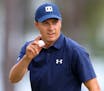Jordan Spieth waves after making a birdie putt on the 16th hole during the first round at the Masters