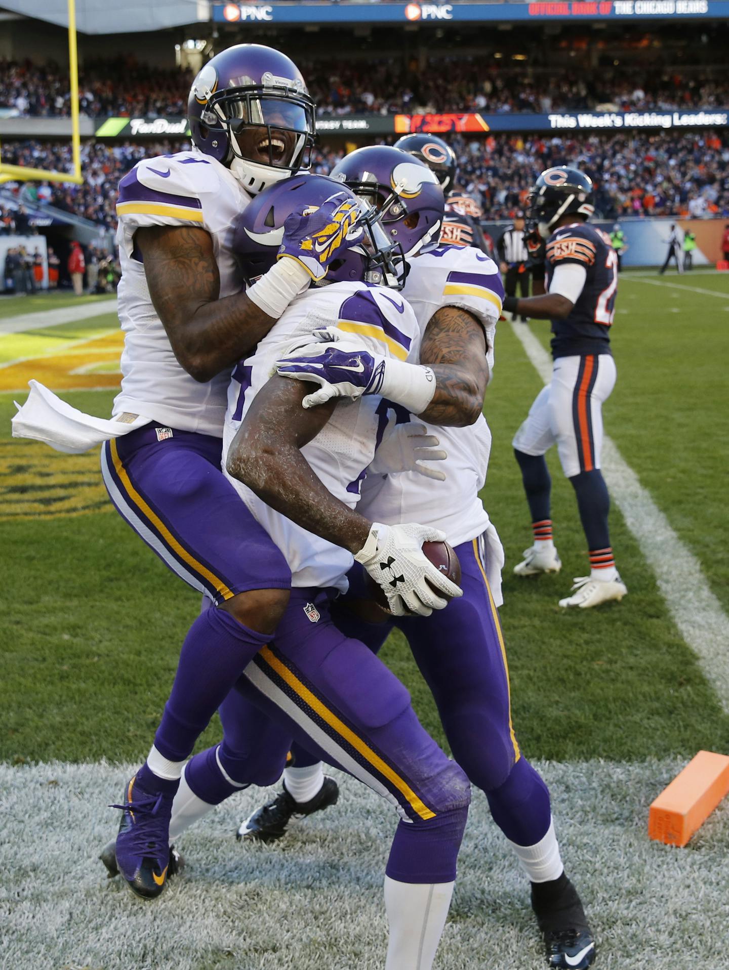 Minnesota Vikings wide receiver Stefon Diggs, center, celebrates his touchdown with teammates Mike Wallace, left, and Matt Asiata during the second half of an NFL football game against the Chicago Bears, Sunday, Nov. 1, 2015, in Chicago. The Vikings won won 23-20. (AP Photo/Charles Rex Arbogast)