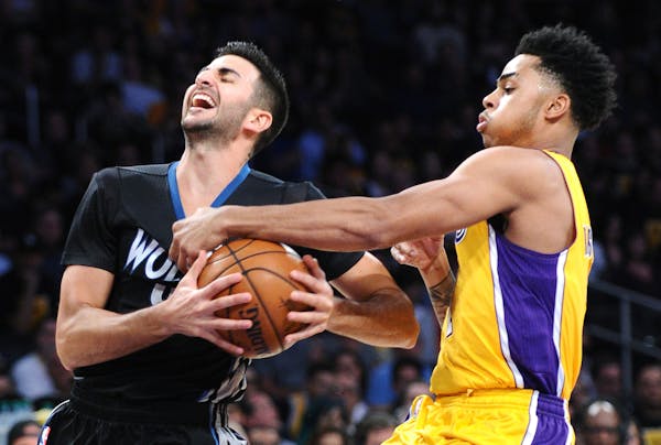 The Los Angeles Lakers' D'Angelo Russell, right, fouls the Minnesota Timberwolves' Ricky Rubio in the first quarter at Staples Center in Los Angeles o