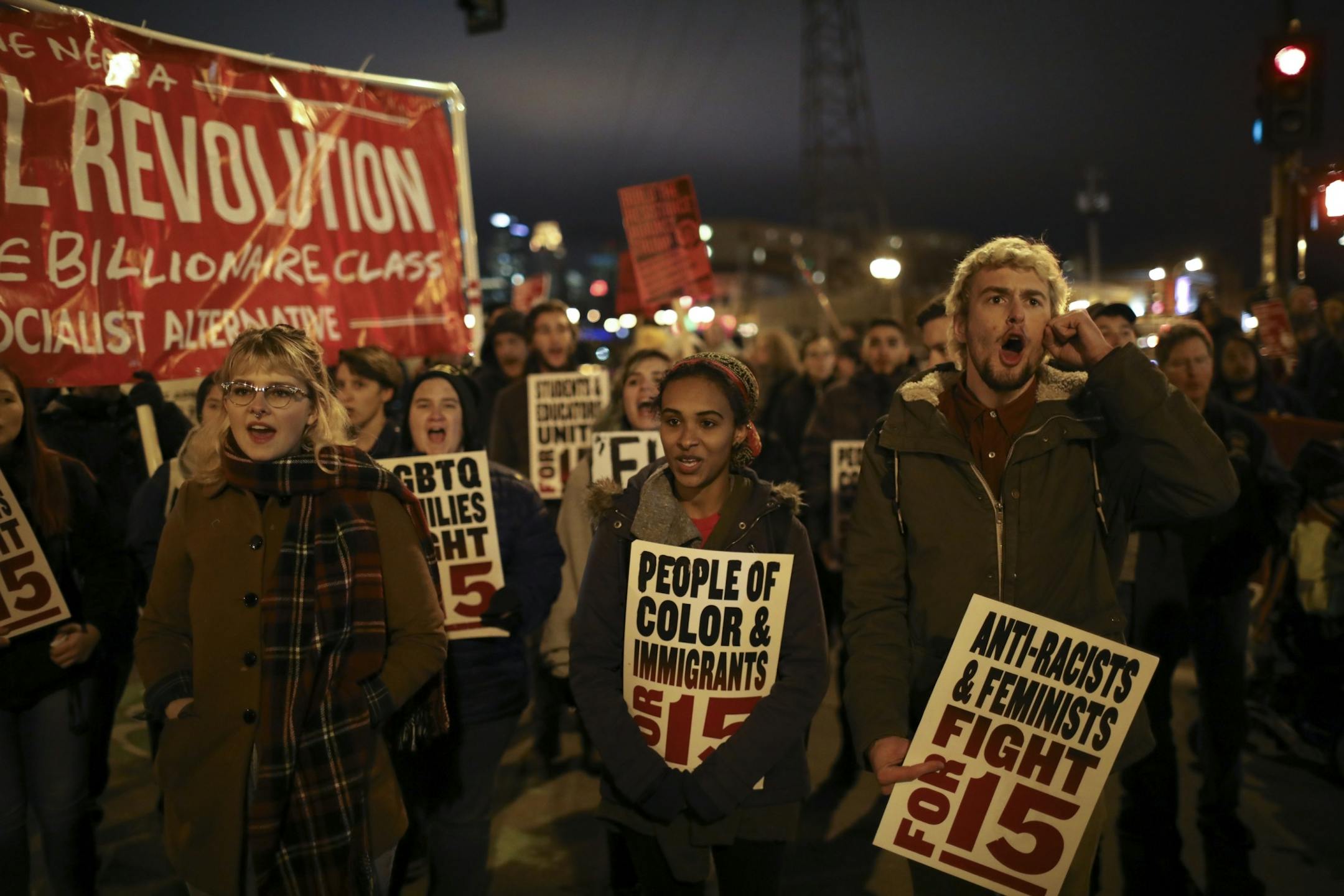 Demonstrators blocked the intersection of 15th Ave. SE and 4th St. SE in Dinkytown and listened to speakers.
