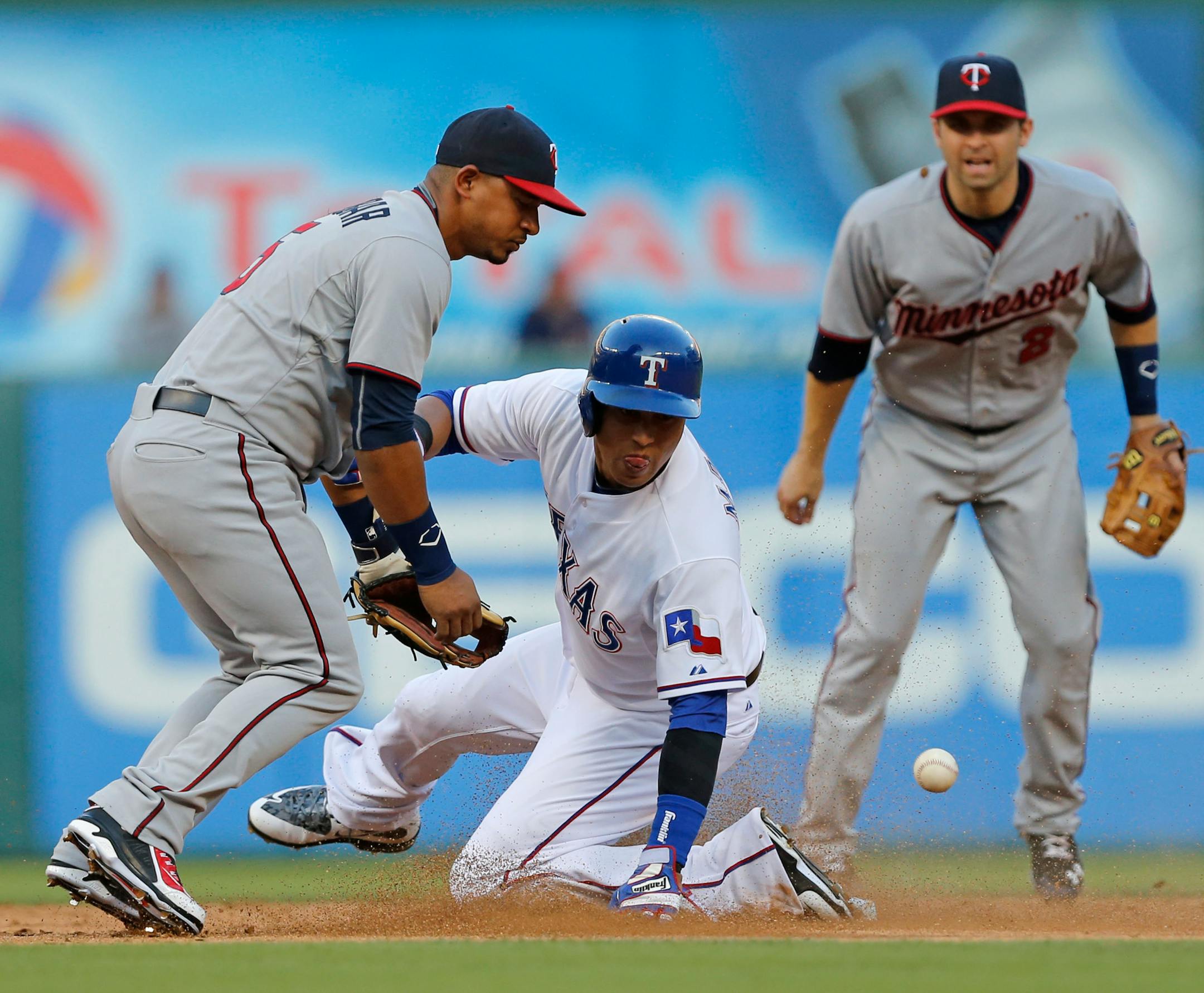 The Texas Rangers' Leonys Martin steals second as Minnesota Twins shortstop Eduardo Escobar, left, cannot handle the ball in the third inning at Globe Life Park in Arlington, Texas, on Friday, June 12, 2015. (Rodger Mallison/Fort Worth Star-Telegram/TNS) ORG XMIT: 1169446