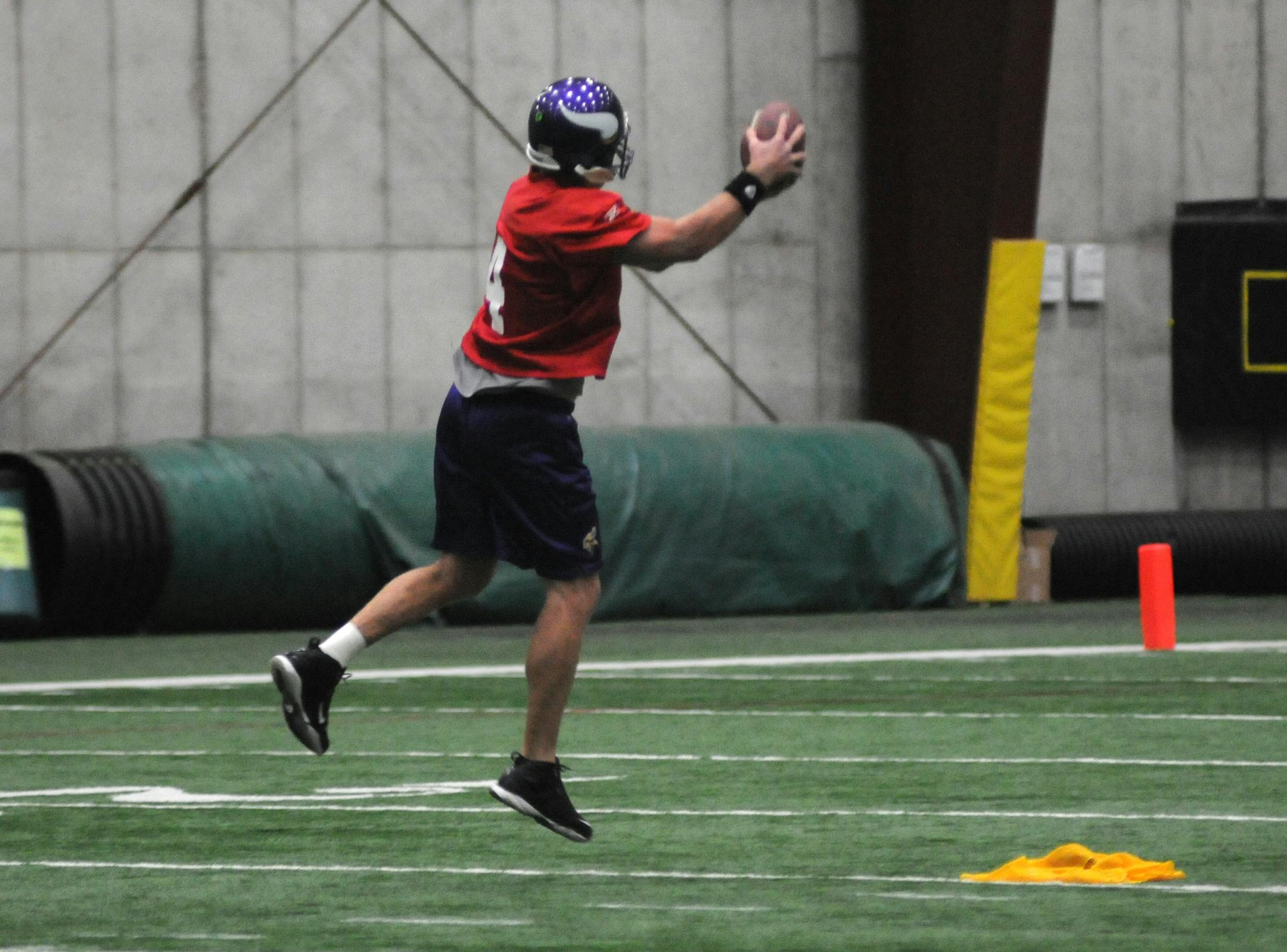 Vikings practice at Winter Park. Brett Favre practiced without his cast and passed to his receivers. Favre leaps for the football, landing on his right foot first.