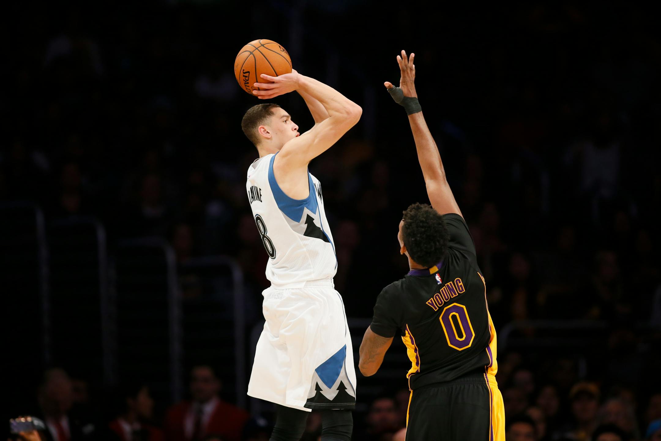 Minnesota Timberwolves' Zach LaVine shoots over Los Angeles Lakers' Nick Young during the second half of an NBA basketball game Friday, Nov. 28, 2014, in Los Angeles. The Timberwolves won 120-119. (AP Photo/Danny Moloshok)