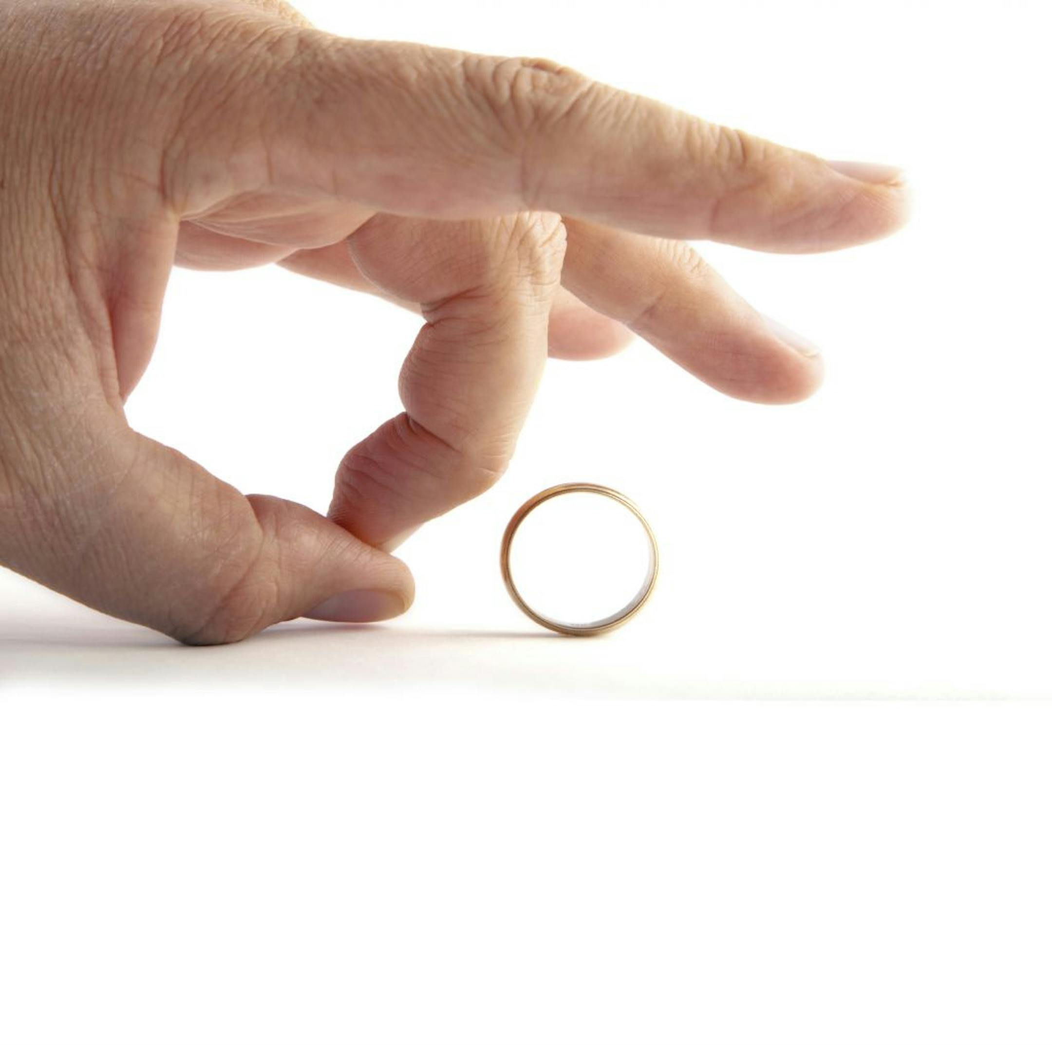 Man flicking a wedding ring.