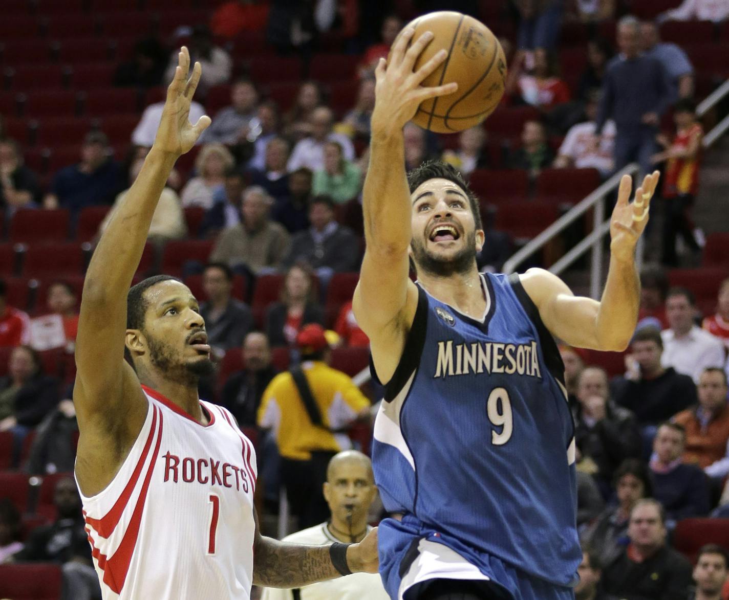 Minnesota Timberwolves' Ricky Rubio (9) goes up for a shot as Houston Rockets' Trevor Ariza (1) defends during the first quarter of an NBA basketball game Wednesday, Jan. 13, 2016, in Houston. (AP Photo/David J. Phillip)