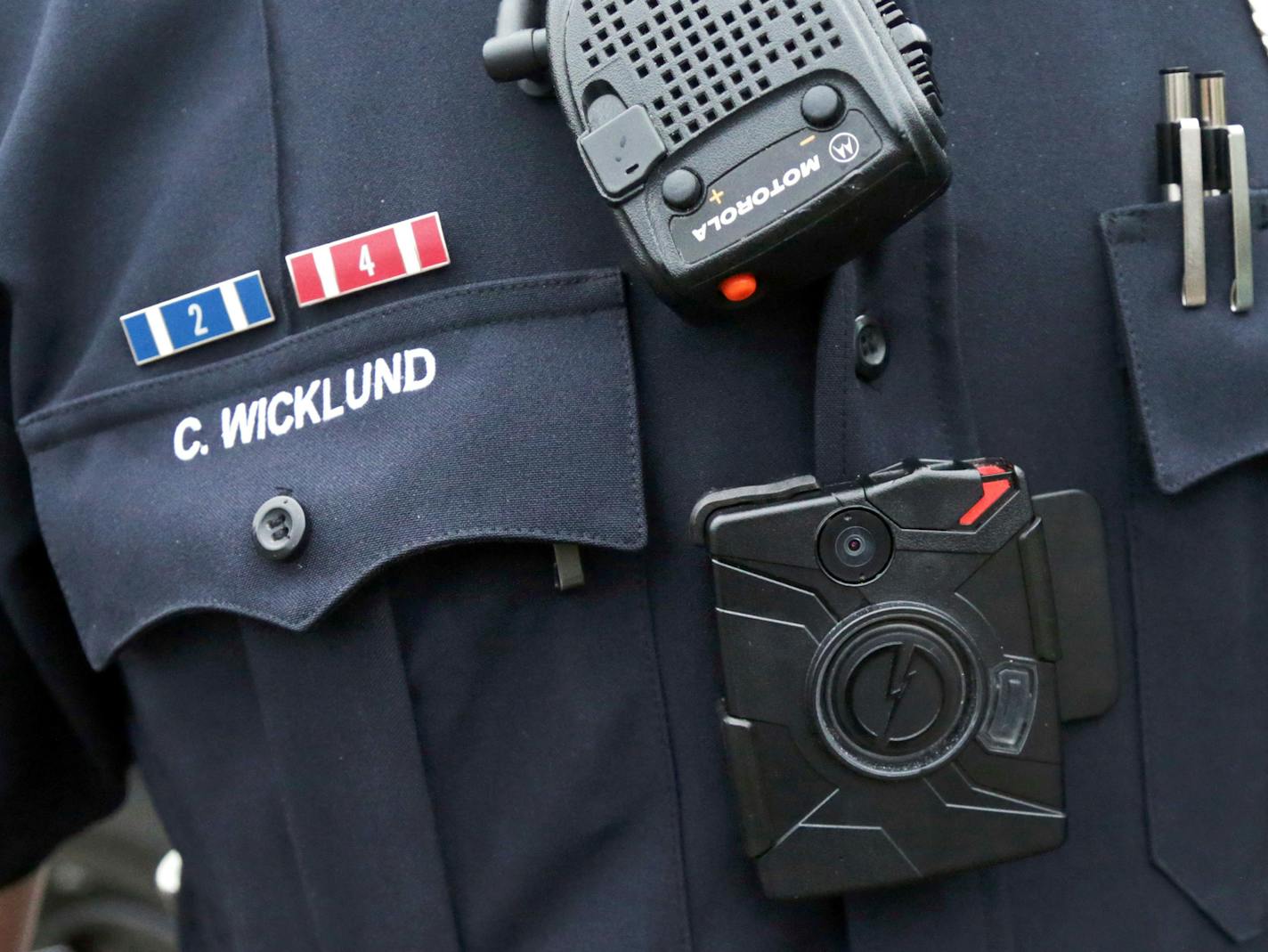 FILE- In this Nov. 5, 2014, file photo, Burnsville Police Department Sgt. Chris Wicklund wears a camera beneath his microphone. As the Minnesota legislature convenes Tuesday, lawmakers are worried about cameras on police officers, squad cars and in the skies. The emerging use of body cameras on police officers has prompted calls for ground rules on how the data should be kept. (AP Photo/Jim Mone, File)