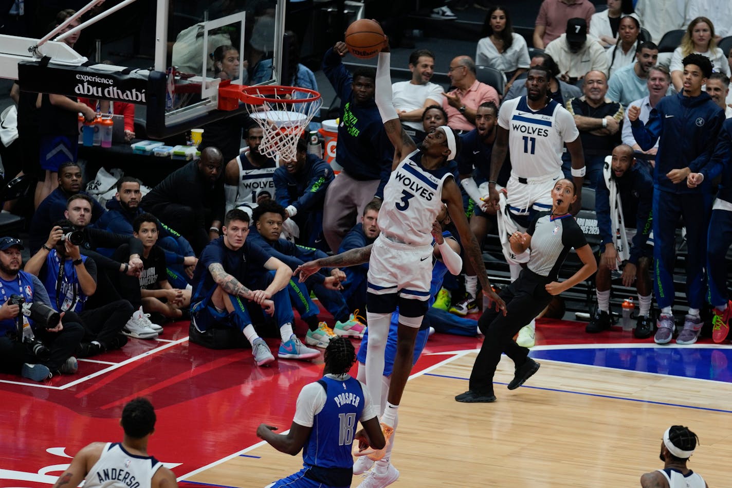 Jaden McDaniels of Minnesota Timberwolves dunks during a preseason NBA basketball game between the Dallas Mavericks and Minnesota Timberwolves in Abu Dhabi, United Arab Emirates, Thursday, Oct. 5, 2023. (AP Photo/Kamran Jebreili)