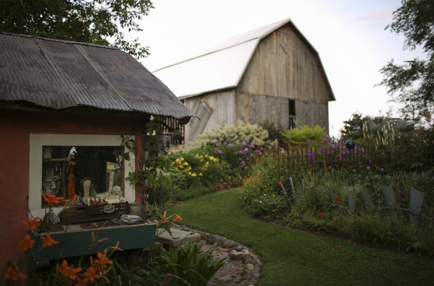 Flower beds and outbuildings in Wouterina de Raad's garden last summer. ] JEFF WHEELER &#xef; jeff.wheeler@startribune.com Artist Wouterina de Raad's garden is a showcase for her concrete mosaic sculptures on her farm in Beldenville, WI. Her gardens were photographed Tuesday, July 29, 2014.