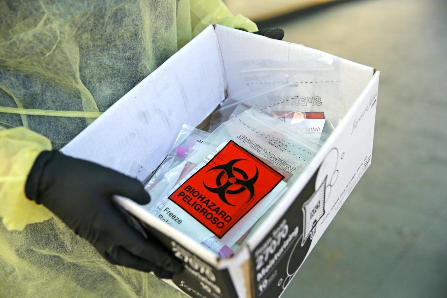 A Florida Department of Health worker holds a box with coronavirus test swabs in Miami on May 7, 2020. (David Santiago/Miami Herald/TNS) ORG XMIT: 1658214