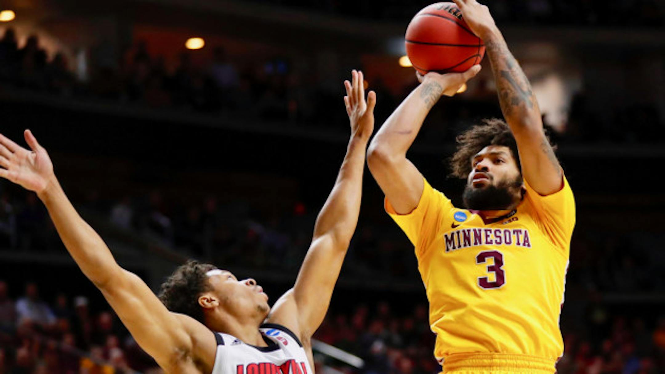 Minnesota forward Jordan Murphy (3) shoots over Louisville forward Dwayne Sutton during a first round men's college basketball game in the NCAA Tournament, Thursday, March 21, 2019, in Des Moines, Iowa. (AP Photo/Charlie Neibergall)