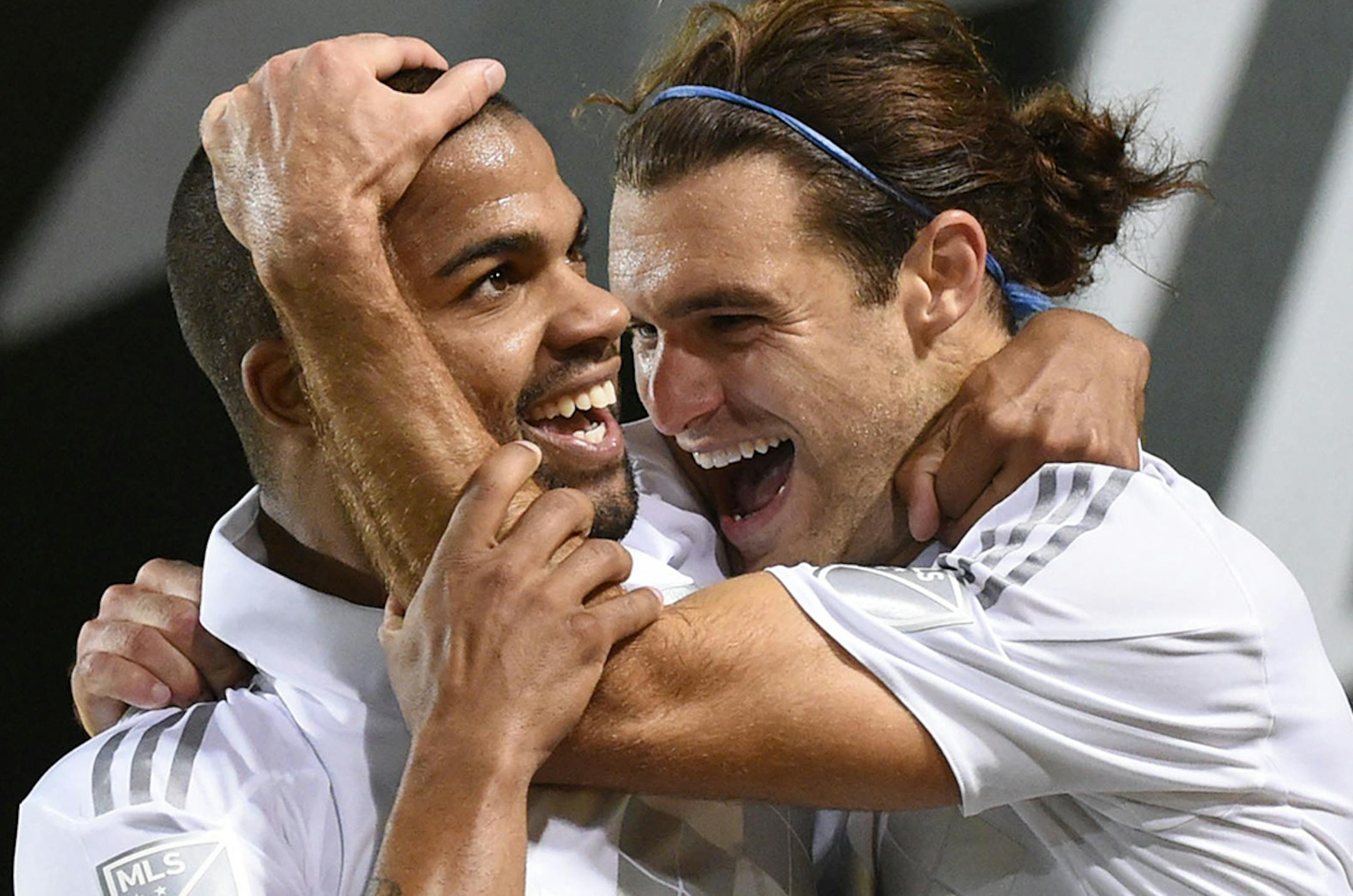 Sporting KC defender Kevin Ellis (4) celebrates with midfielder Graham Zusi (8) after scoring a goal during the second half of a knockout round MLS playoff soccer match against the Portland Timbers in Portland, Ore. on Thursday, Oct. 29, 2015. (AP Photo/Steve Dykes) ORG XMIT: ORSD108