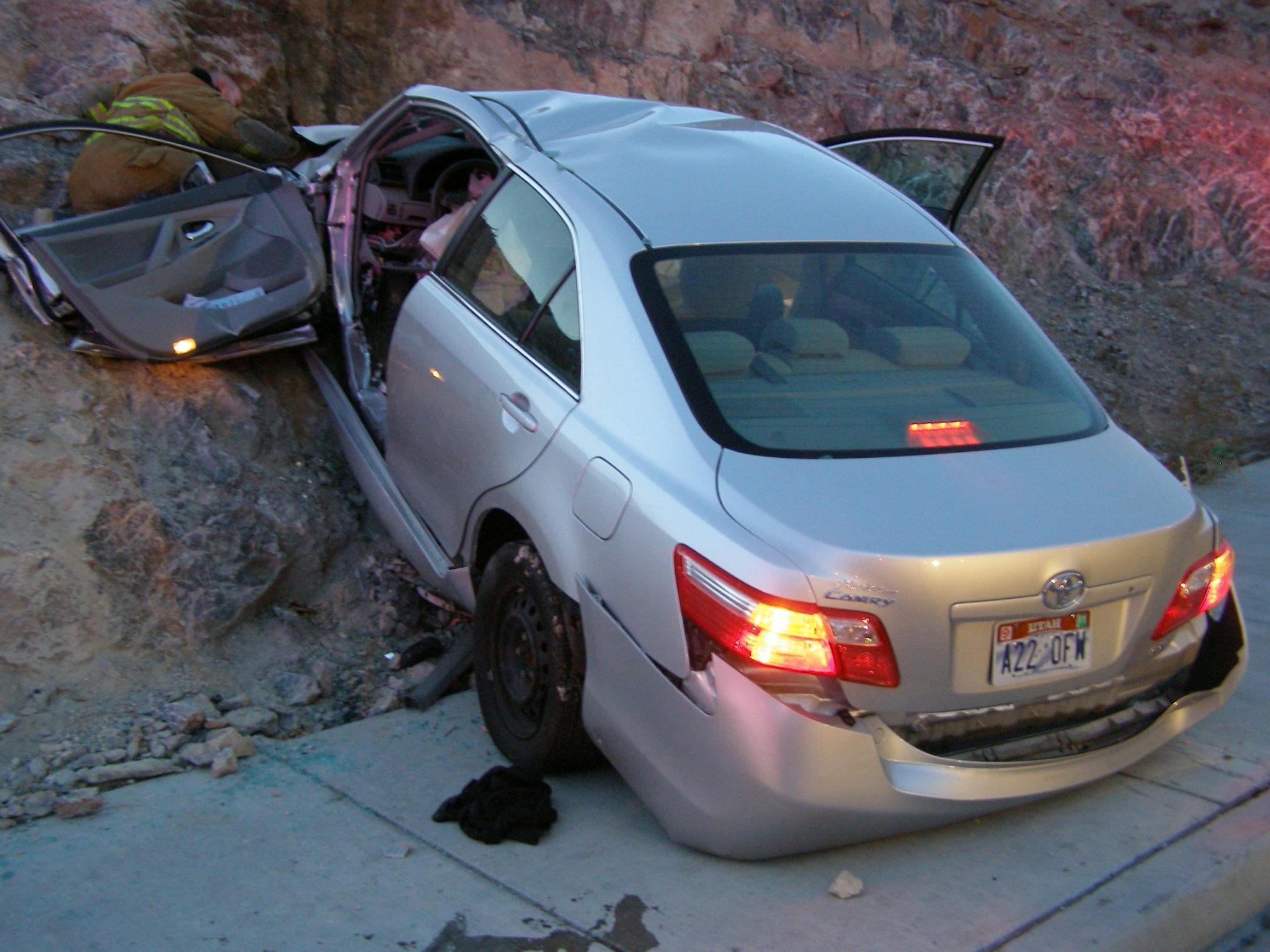 FILE - In this Nov. 5, 2010 file photo released by the Utah Highway Patrol, a Toyota Camry is shown after it crashed as it exited Interstate 80 in Wendover, Utah. Police suspect problems with the Camry's accelerator or floor mat caused the crash that left two people dead and two others injured.