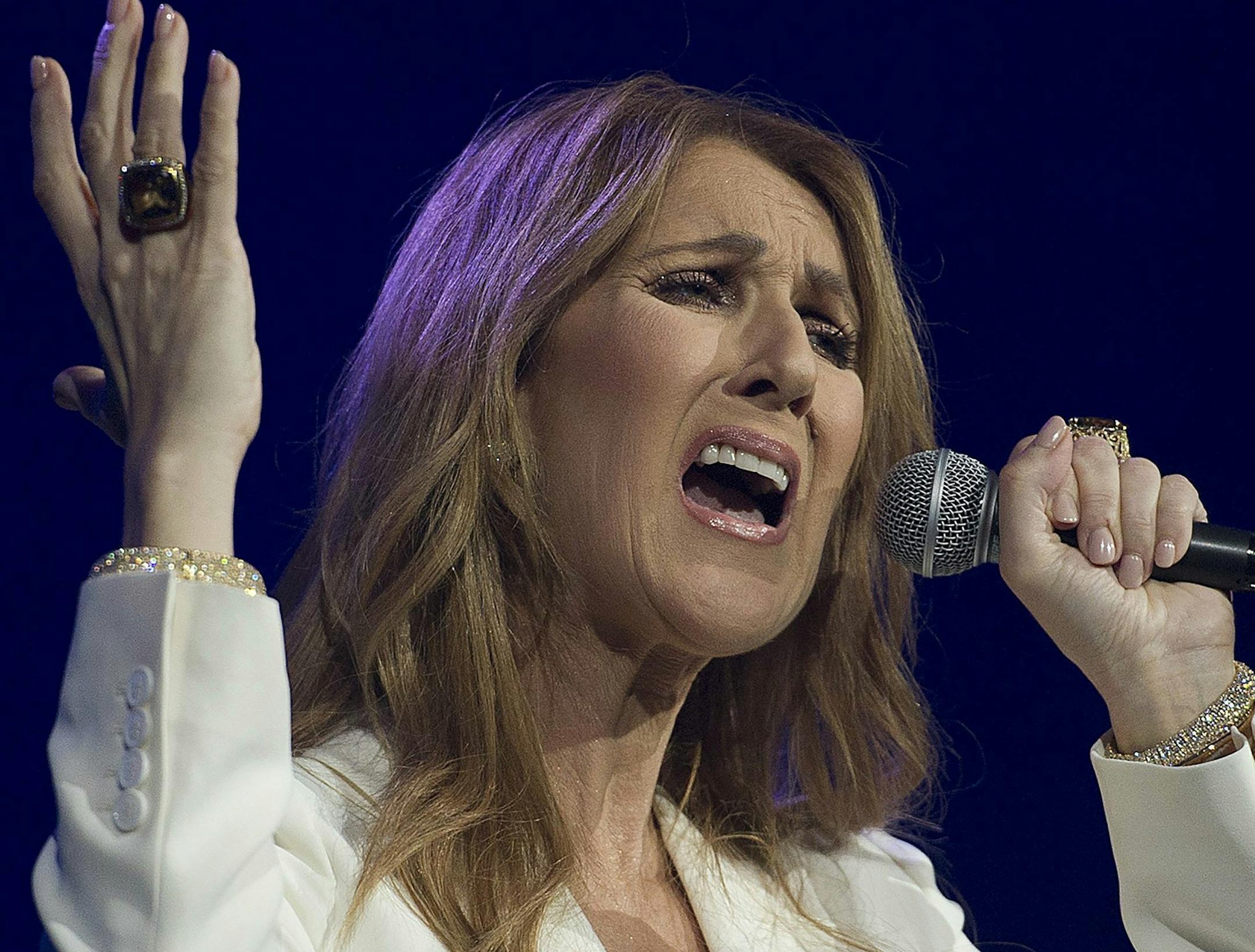 FILE - In this July 31, 2016 file photo, Celine Dion performs in concert at the Bell Centre in Montreal. In the wake of multiple allegations against R. Kelly, some performers are denouncing songs the R&B hitmaker created for them. Dion followed in Lady Gaga's footsteps, removing her Grammy-nominated duet with the embattled singer, R. Kelly, "I'm Your Angel," from streaming platforms. (Graham Hughes/The Canadian Press via AP, File)