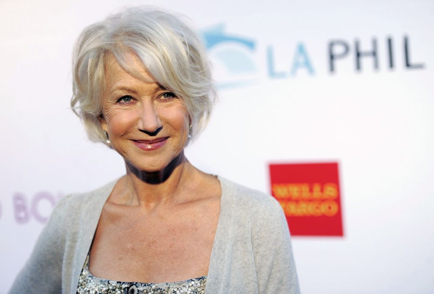 FILE - In this June 17, 2011 file photo, actress Helen Mirren poses at the opening of the 90th season of the Hollywood Bowl in Los Angeles. Gray heads have been popping up on runways and red carpets, on models and young celebrities for months. There's Lady Gaga and Kelly Osbourne _ via dye _ and Hollywood royalty like Oscar-winning British actress Helen Mirren.