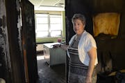 Debby Adams, administrator at Peace United Church of Christ in Rochester, shows how a fire safety door stopped flames set on April 18, 2022, in the ch