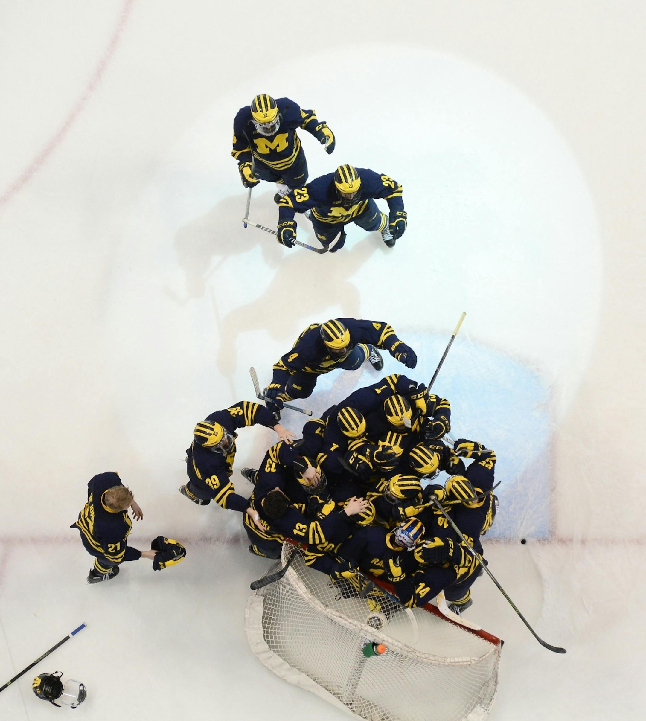 The Michigan Wolverines celebrated their 5-3 Big 10 championship victory over Minnesota Golden Gophers Saturday night.