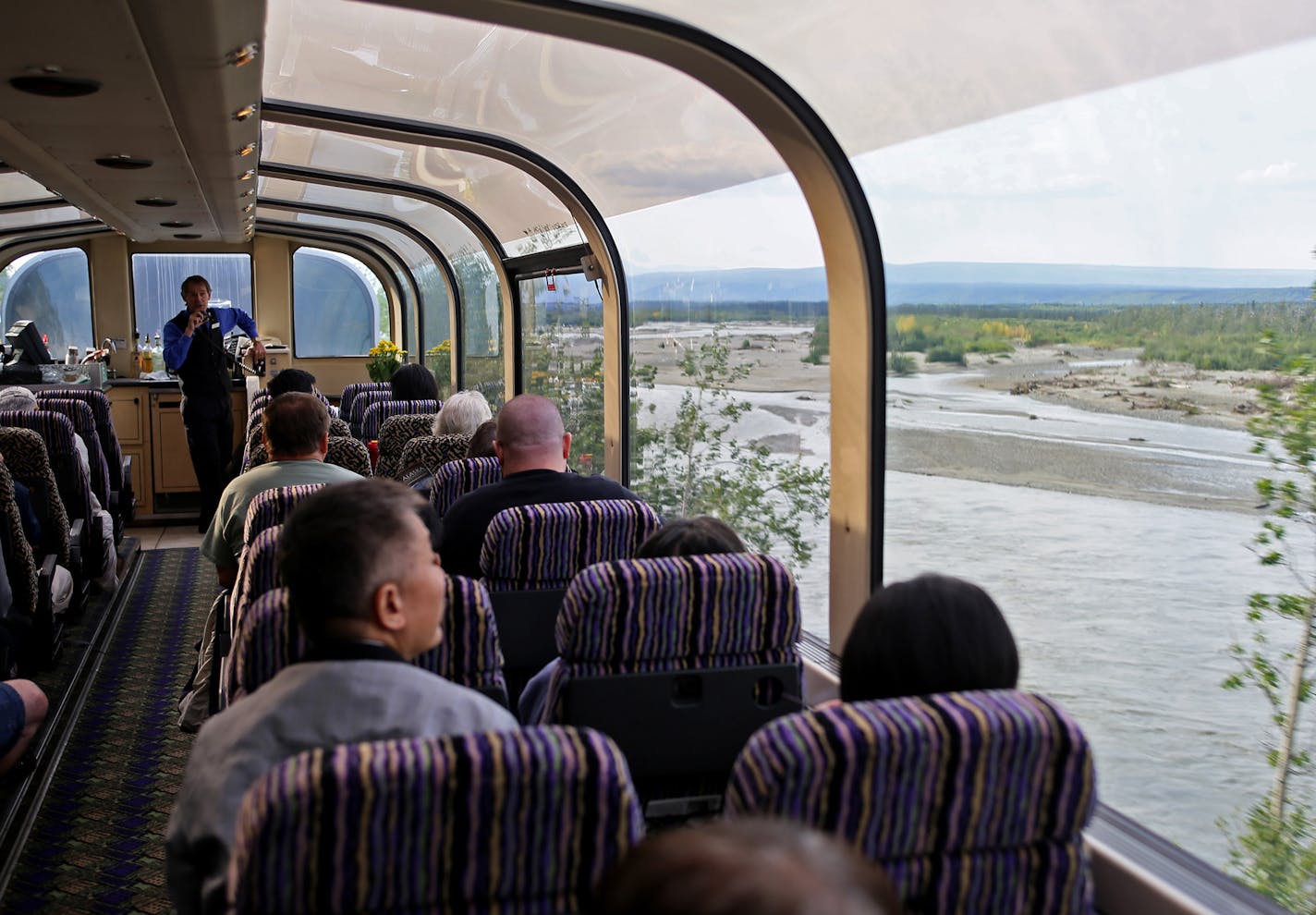 A guide on the dome car of a train from Fairbanks to Denali National Park.