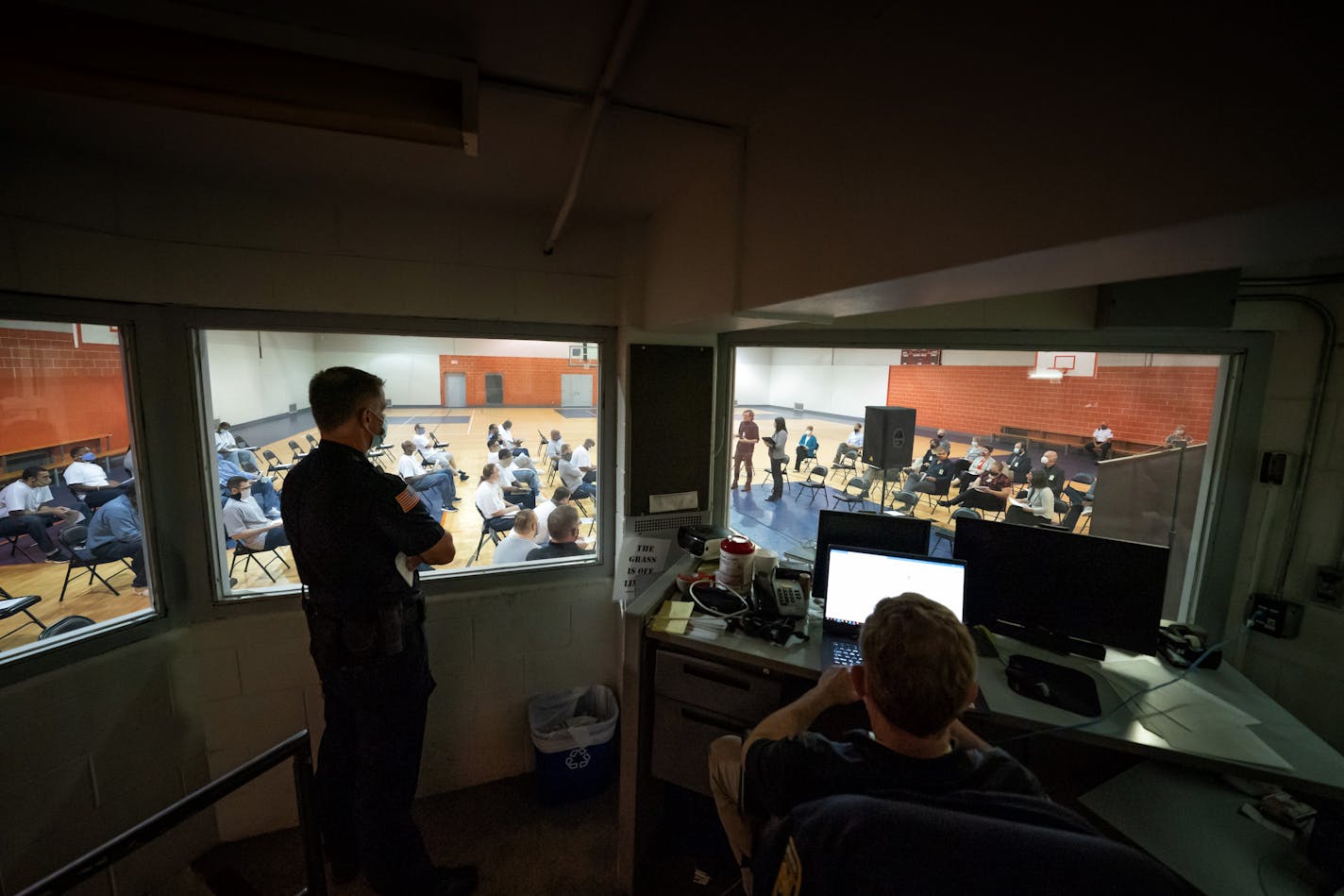 Guards kept watch on the college presentation from a secure control room. Incarcerated students on the left, faculty and administrators on the right.