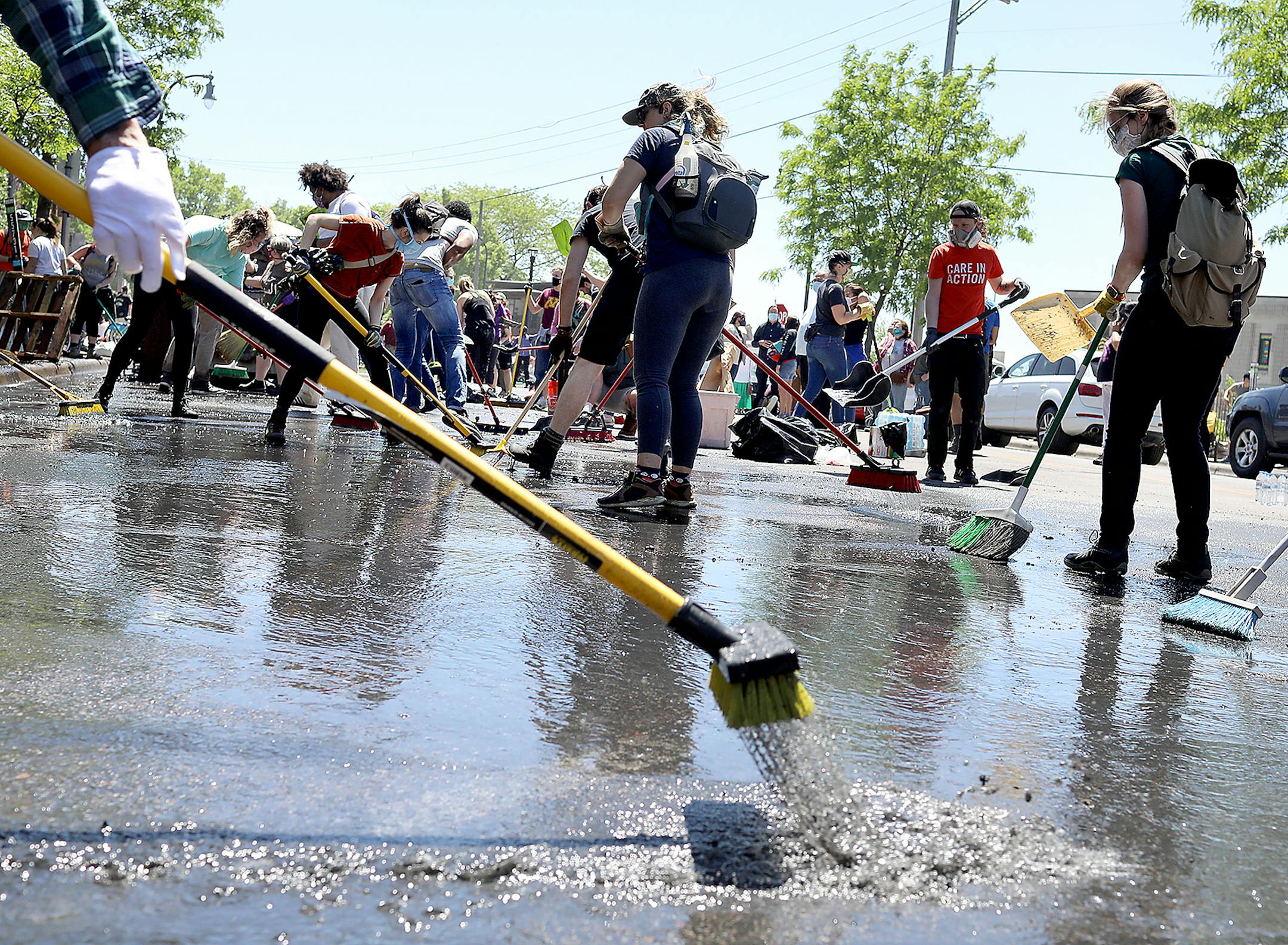 A small army of community members and volunteers work to clear water and debris outside 27 Avenue Cafe, just off of Lake Street, damaged by agitators in the wake of the death of George Floyd while in police custody earlier in the week and seen Saturday, May 30, 2020, in Minneapolis, MN.] DAVID JOLES • david.joles@startribune.com Latest on the death of George Floyd.