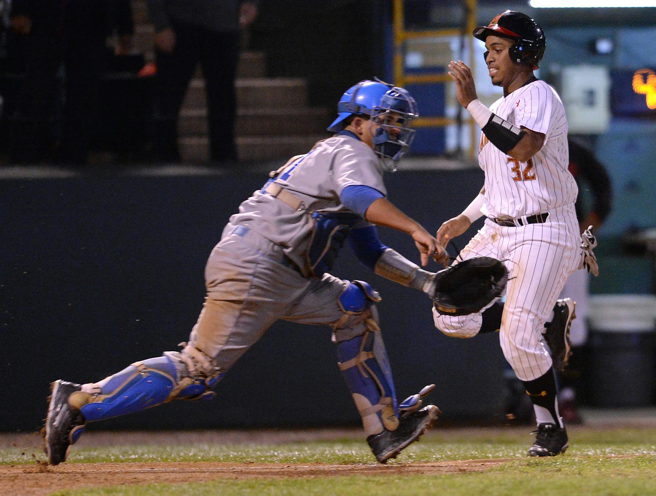 Maryland's Kevin Martir scored past UCLA's Darrell Miller Jr. during the fourth inning on Monday night's regional final in Los Angeles. The Terrapins stunned the top-seeded Bruins 2-1 to advance to a super regional against Virginia.