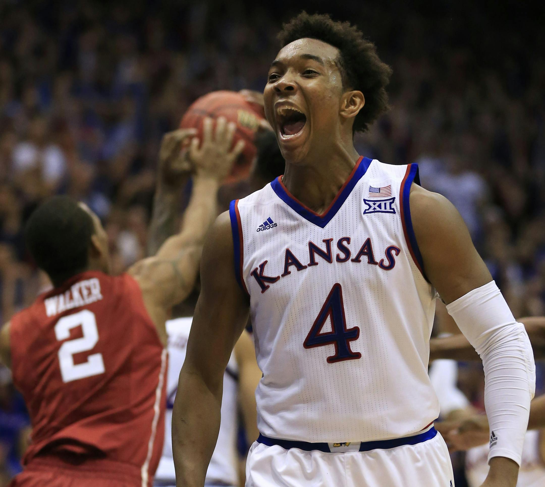 Kansas guard Devonte' Graham (4) celebrates at the end of an NCAA college basketball game against Oklahoma in Lawrence, Kan., Monday, Jan. 4, 2016. Kansas defeated Oklahoma 109-106 in triple overtime. (AP Photo/Orlin Wagner)