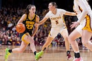 Caitlin Clark (22) of the Iowa Hawkeyes is defended by Maggie Czinano (5) Minnesota Golden Gophers in the third quarter Wednesday,