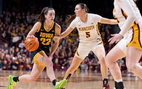 Caitlin Clark (22) of the Iowa Hawkeyes is defended by Maggie Czinano (5) Minnesota Golden Gophers in the third quarter Wednesday,