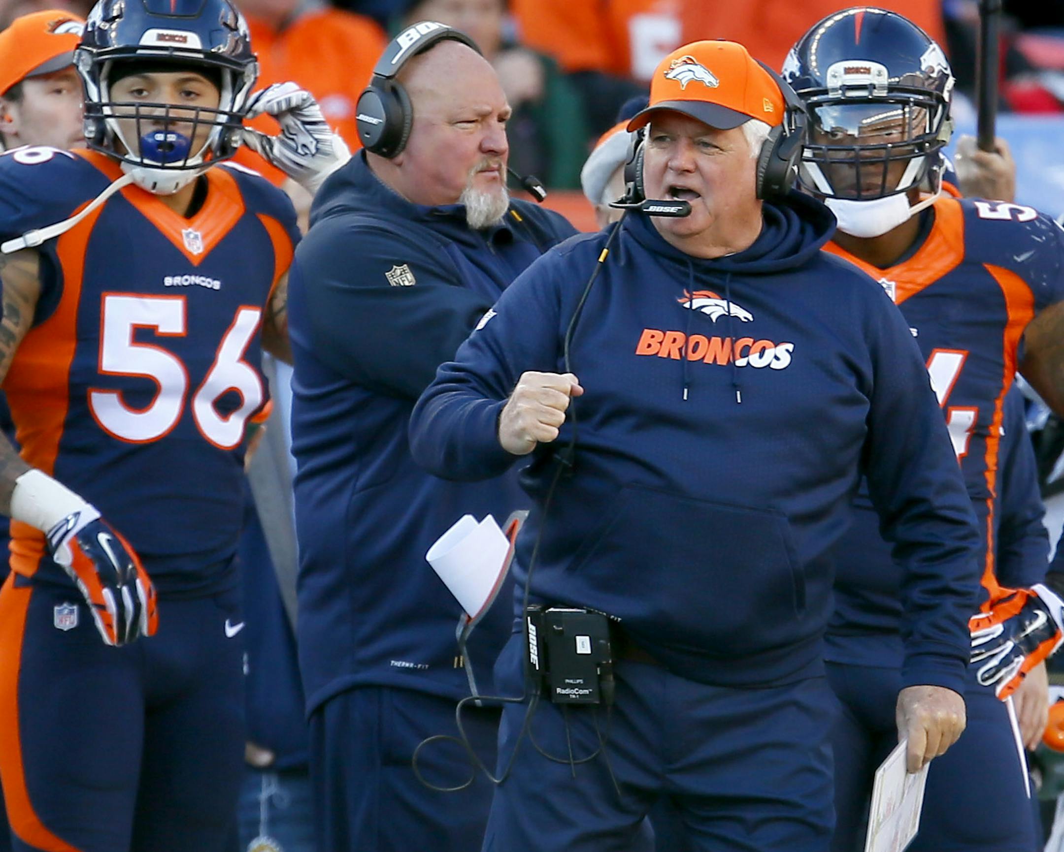 FILE - In this Dec. 13, 2015, file photo, Denver Broncos defensive coordinator Wade Phillips pumps his fist during the first half of an NFL football game against the Oakland Raiders in Denver. The Broncos defensive coordinator is a character cut from the same cloth as his dad, quick with a quip and as good a teacher as he is a tactician. (AP Photo/Joe Mahoney, File) ORG XMIT: NY155