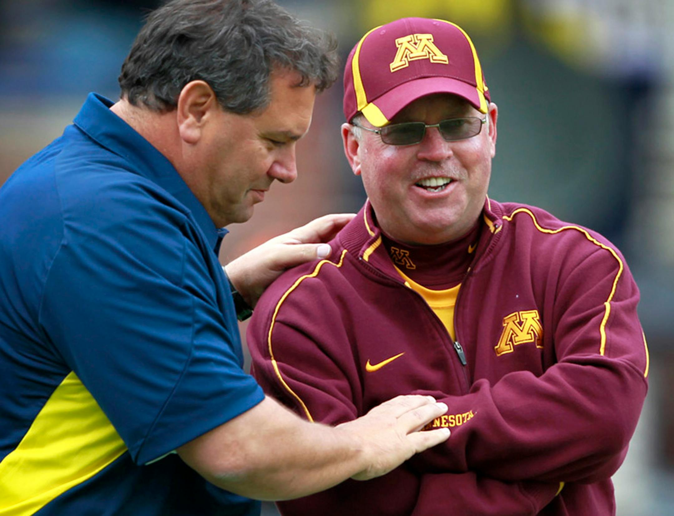 Minnesota head coach Jerry Kill and Michigan head coach Brody Hoke