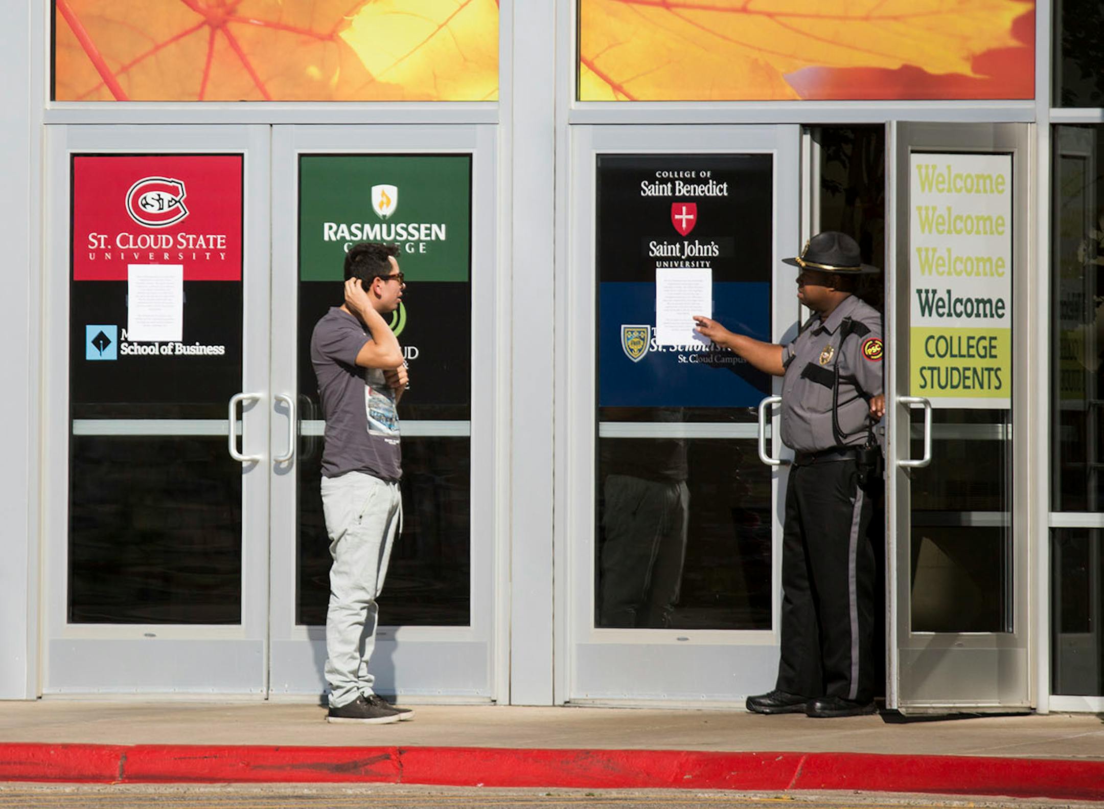 A security officer explains to a man that the Crossroads Center is closed for the day.