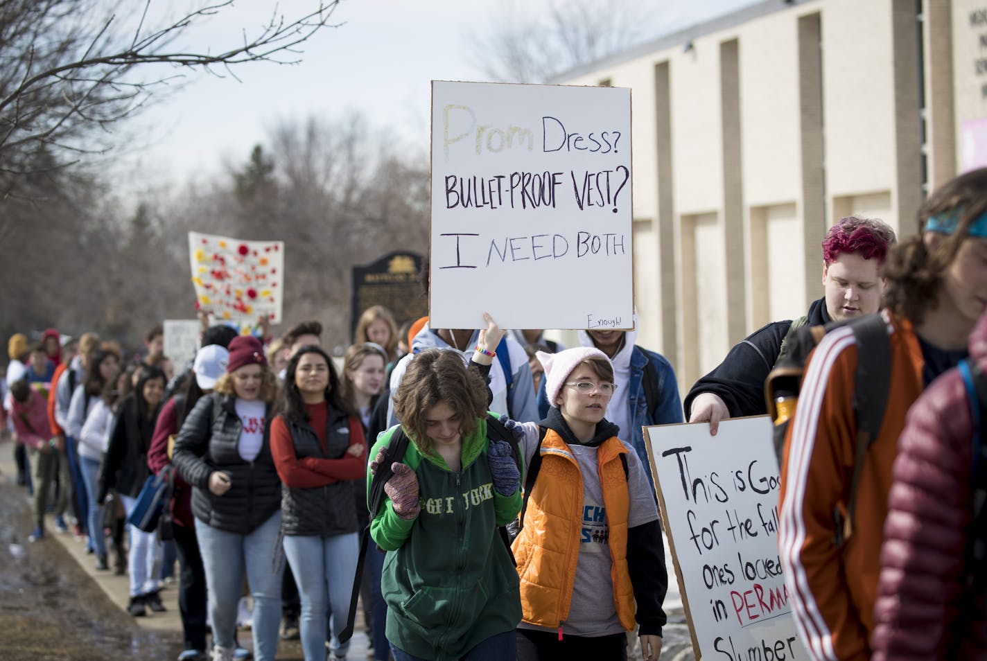 Highland Park Senior High student Faith Hodge, 16, held a sign reading "Prom dress? Bulletproof vest? I need both," during a walkout on the 19th anniversary of the Columbine school shooting on Friday, April 20, 2018 in St. Paul, Minn. ] RENEE JONES SCHNEIDER &#x2022; renee.jones@startribune.com