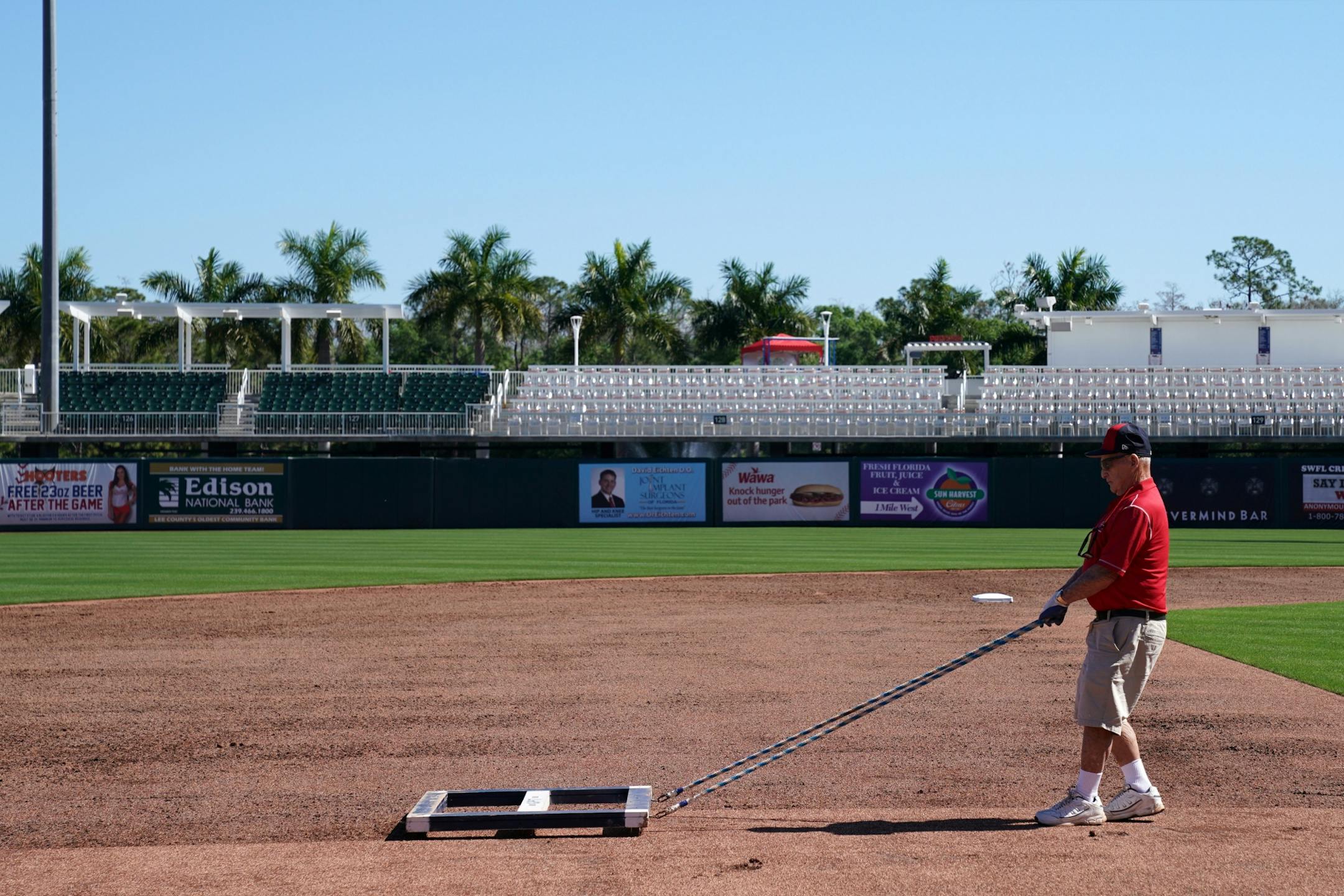 Groundskeeper George Toma raked the infield at Hammond Stadium Thursday morning.