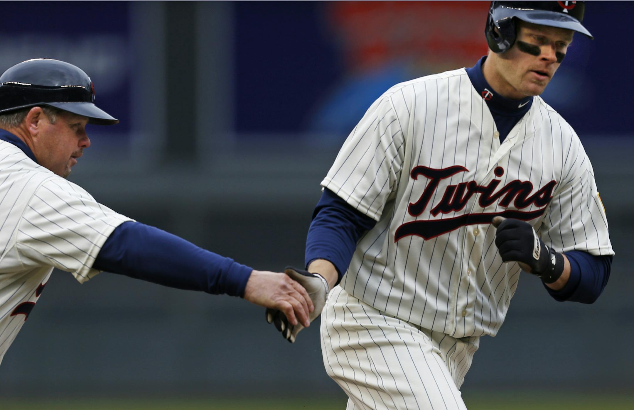 At the Twins game against the Mets on 3/13/13, 3rd base coach Joe Vavra congratulates Justin Morneau as he homered to right, breaking up Matt Harvey"s no-hitter in the seventh inning .]rtsong-taatarii@startribune.com
