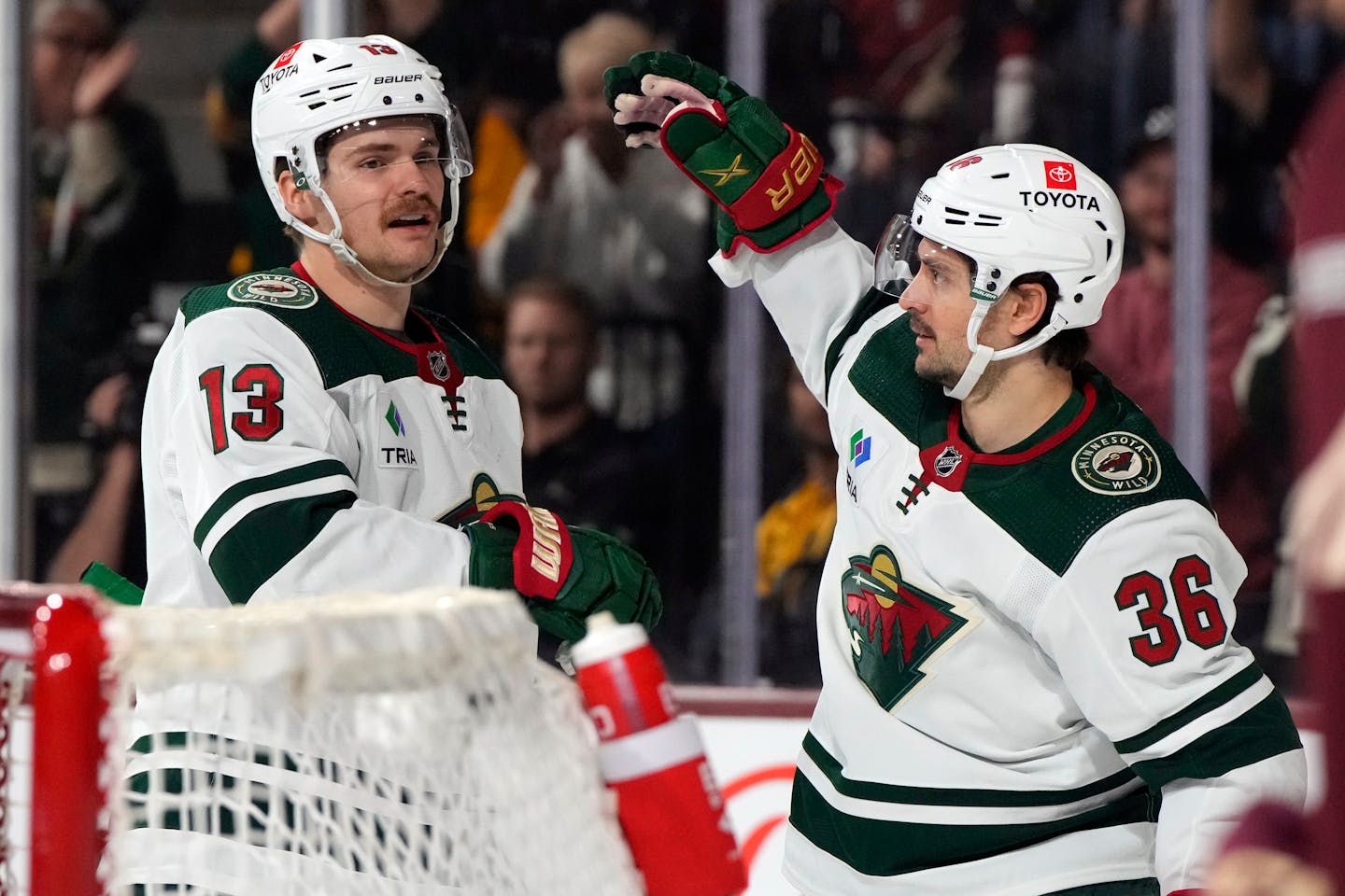 Minnesota Wild right wing Mats Zuccarello (36) celebrates with center Sam Steel after scoring a goal against the Arizona Coyotes in the first period during an NHL hockey game, Sunday, March 12, 2023, in Tempe, Ariz. (AP Photo/Rick Scuteri)