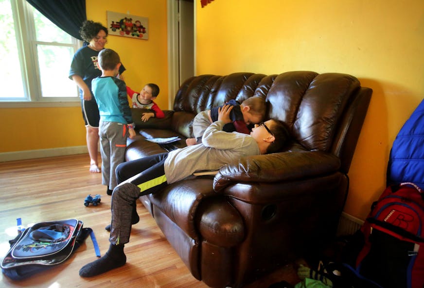 So that his mom Andrea can talk to his other siblings, Mark watches over Isaac, 18 months, before school begins for the day Wednesday, May 18, 2016, in New Hope, MN.(DAVID JOLES/STARTRIBUNE)djoles@startribune Each day, an estimated 30,000 to 40,000 children across Minnesota provide care to someone in their family who is physically or mentally disabled and is too debilitated to care for themselves. Across Minnesota, from Fairmont to Duluth, school and county social workers say the numbers of chil