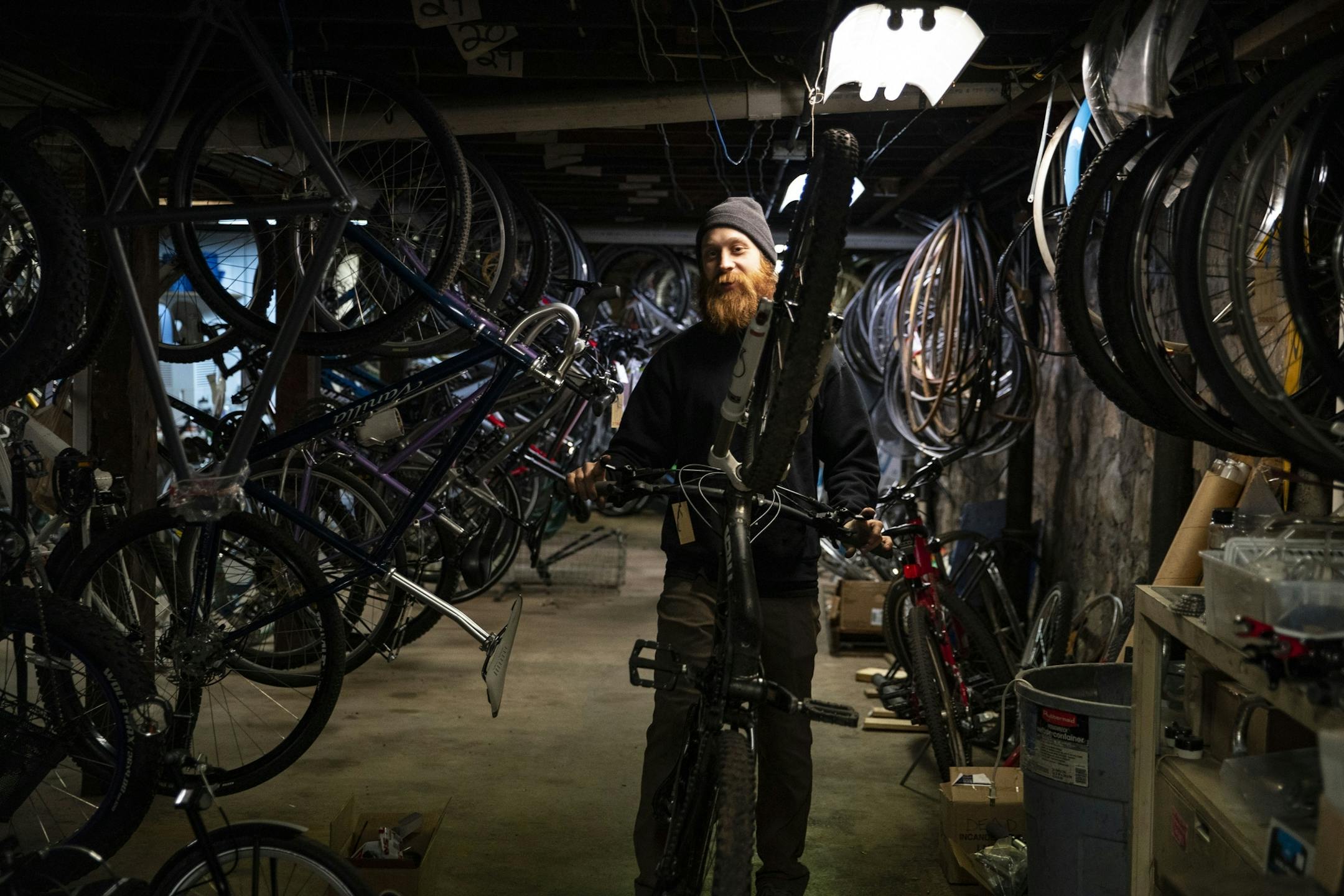 Cassidy Olson a mechanic at Twin Ports Cyclery wheeled a bike to the rack to be repaired on Friday afternoon.